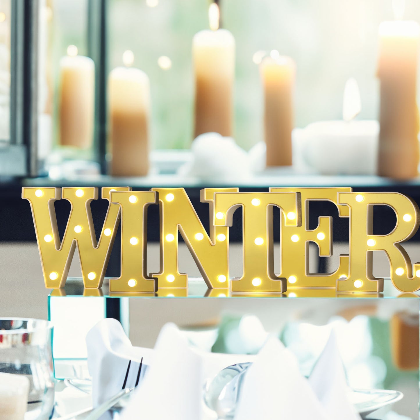 Gold light-up marquee letters spelling "WINTER" with warm white LEDs.