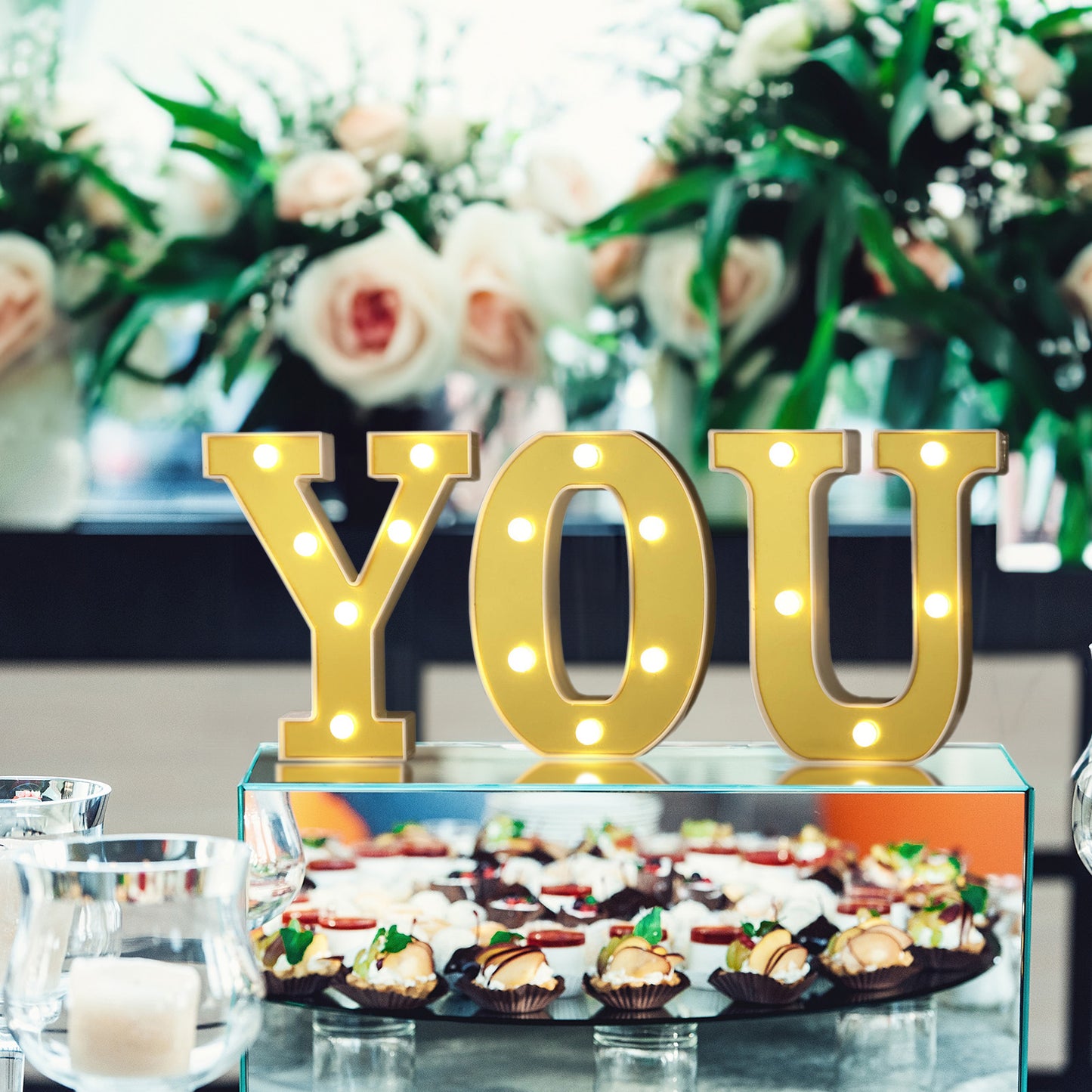 Gold 3D marquee letters "YOU" with warm white LED lights.