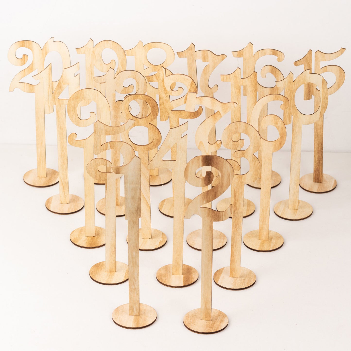 Set of 20 natural wooden wedding table numbers on sticks with round base.