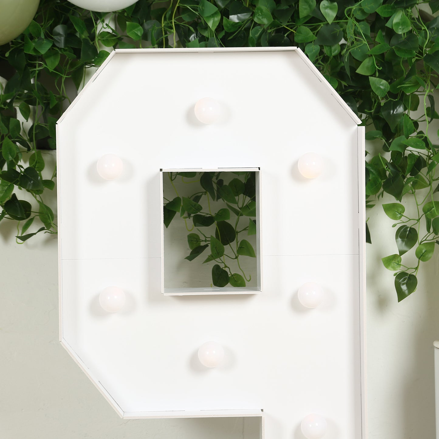 White giant LED marquee number "9" with warm white lights.