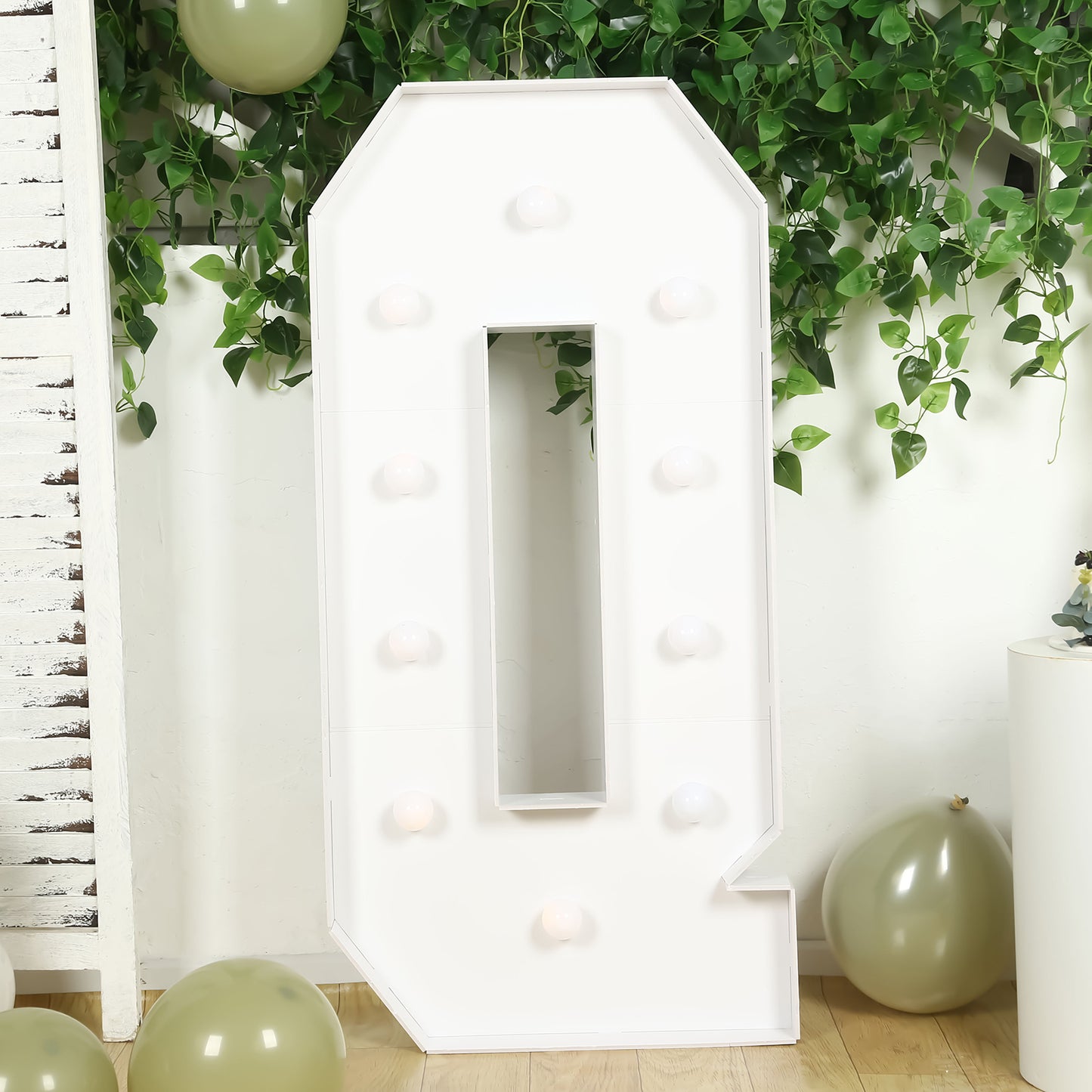 White giant LED marquee letter "Q" with warm white lights.