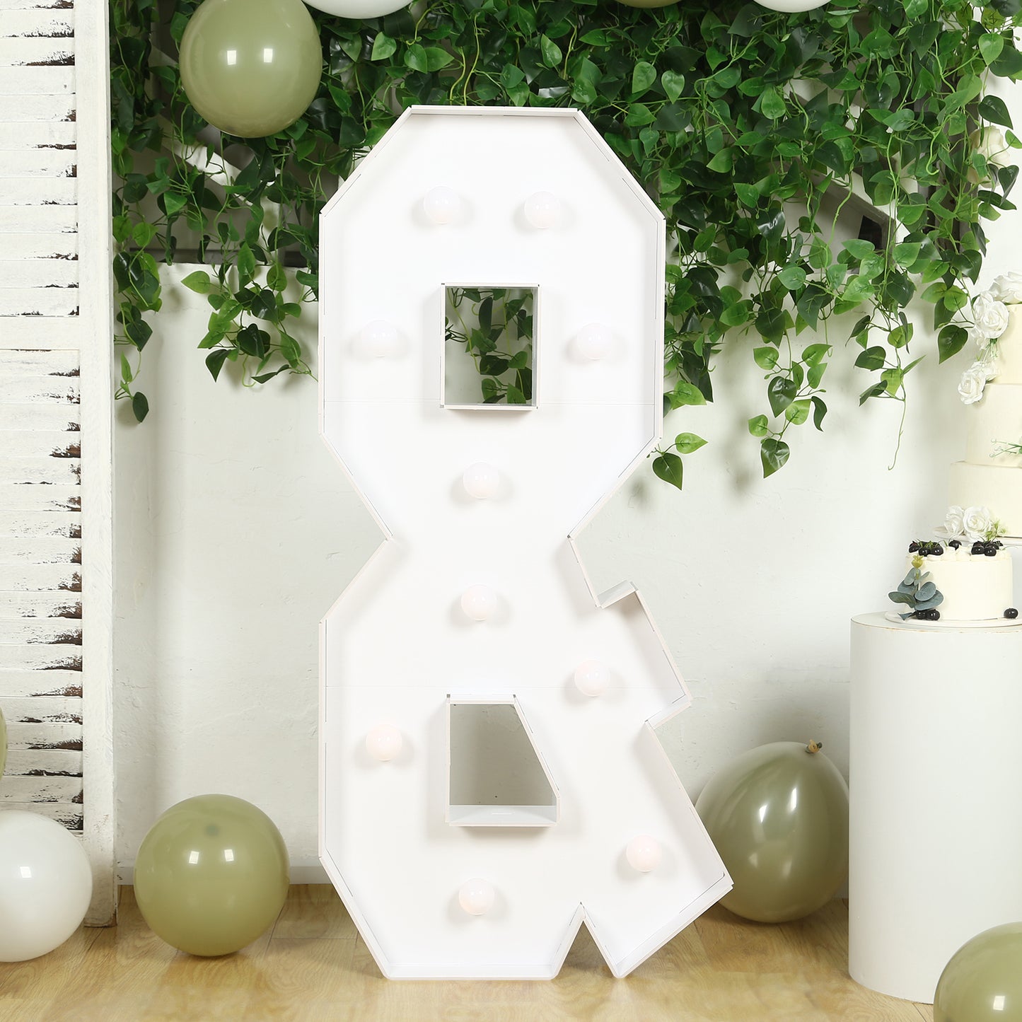White giant LED marquee "&" symbol with warm white lights.