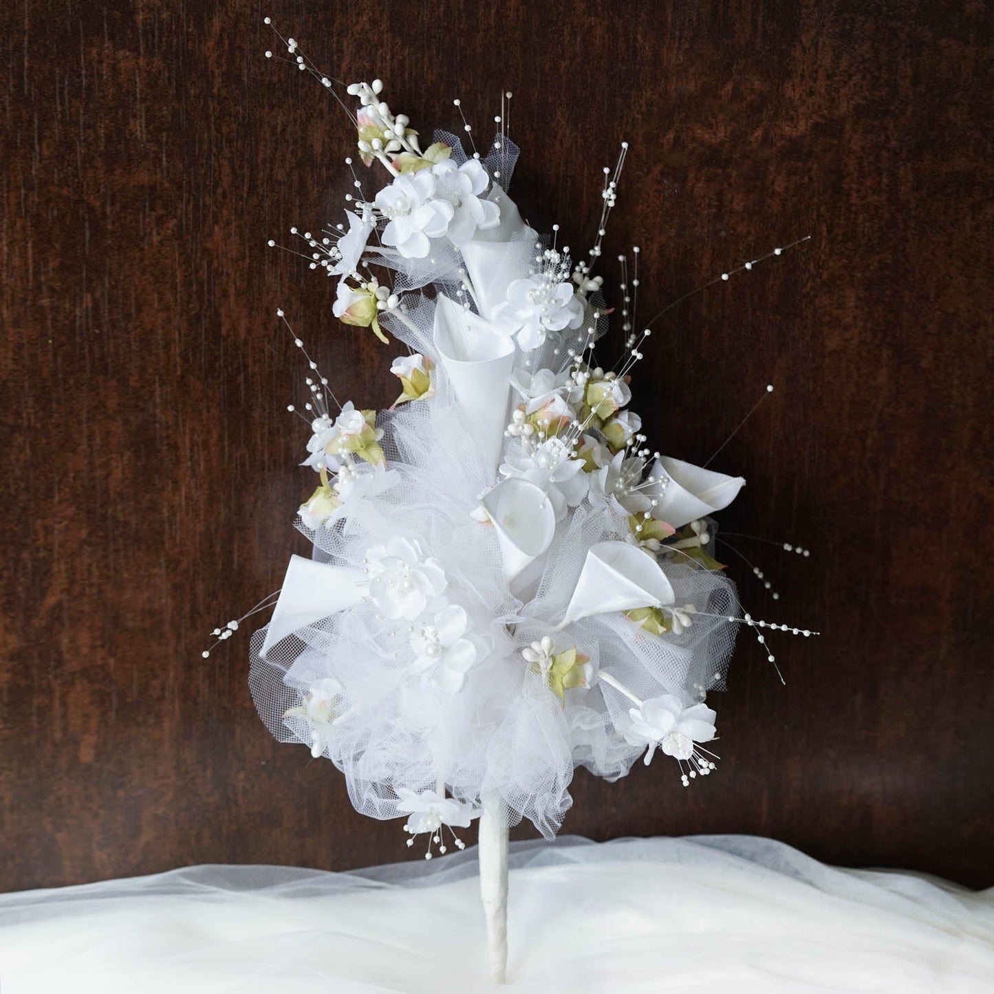 White artificial lily and tulip bridal bouquet flowers.