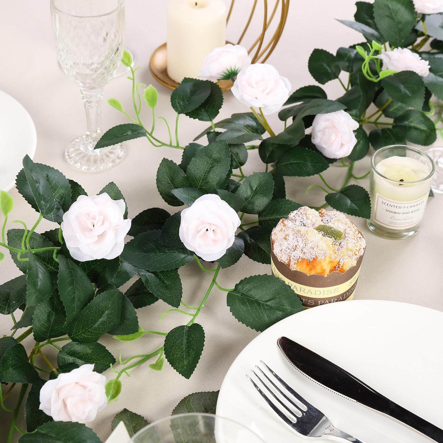 Blush artificial silk roses garland vine on table setting.