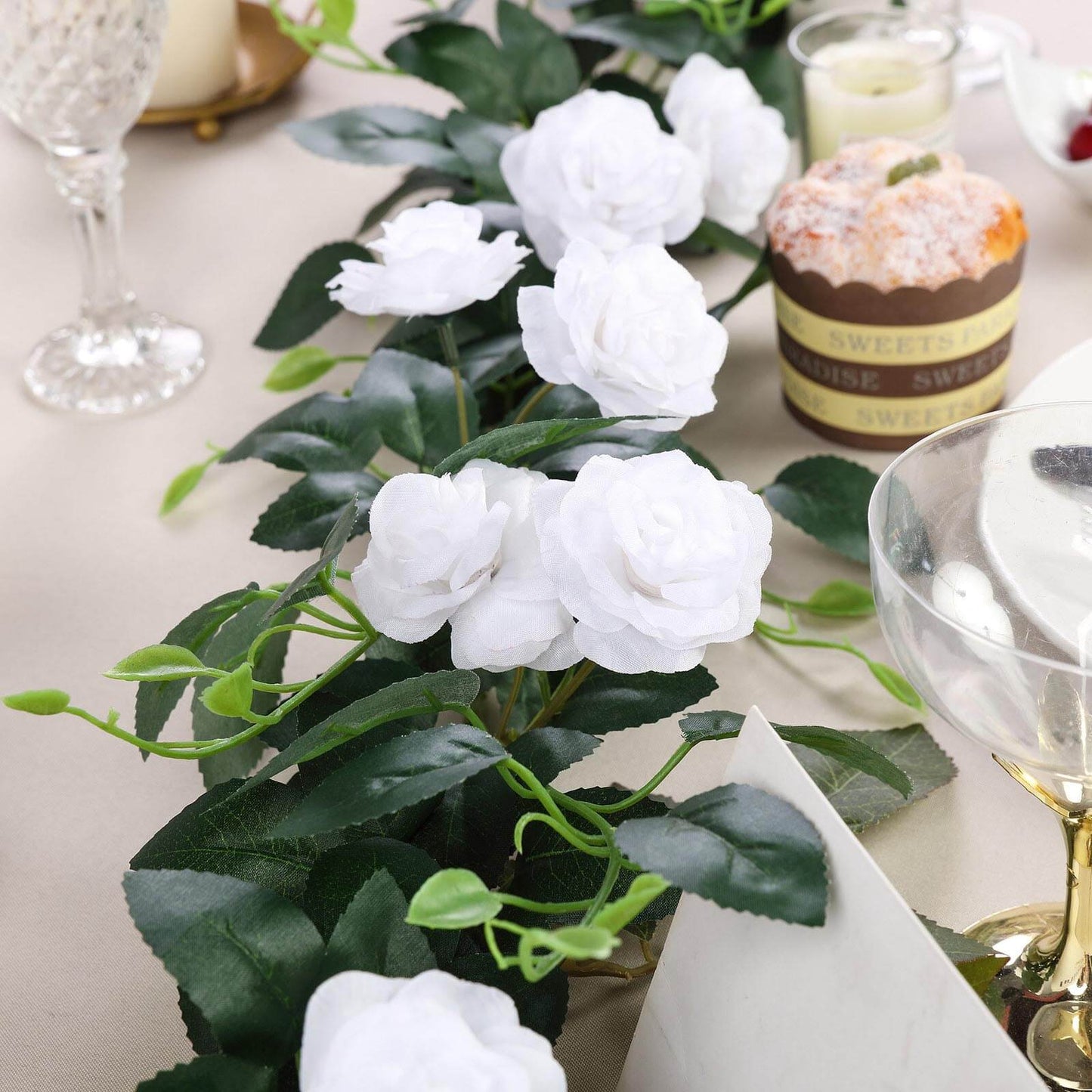 White artificial silk roses flower garland for decor.