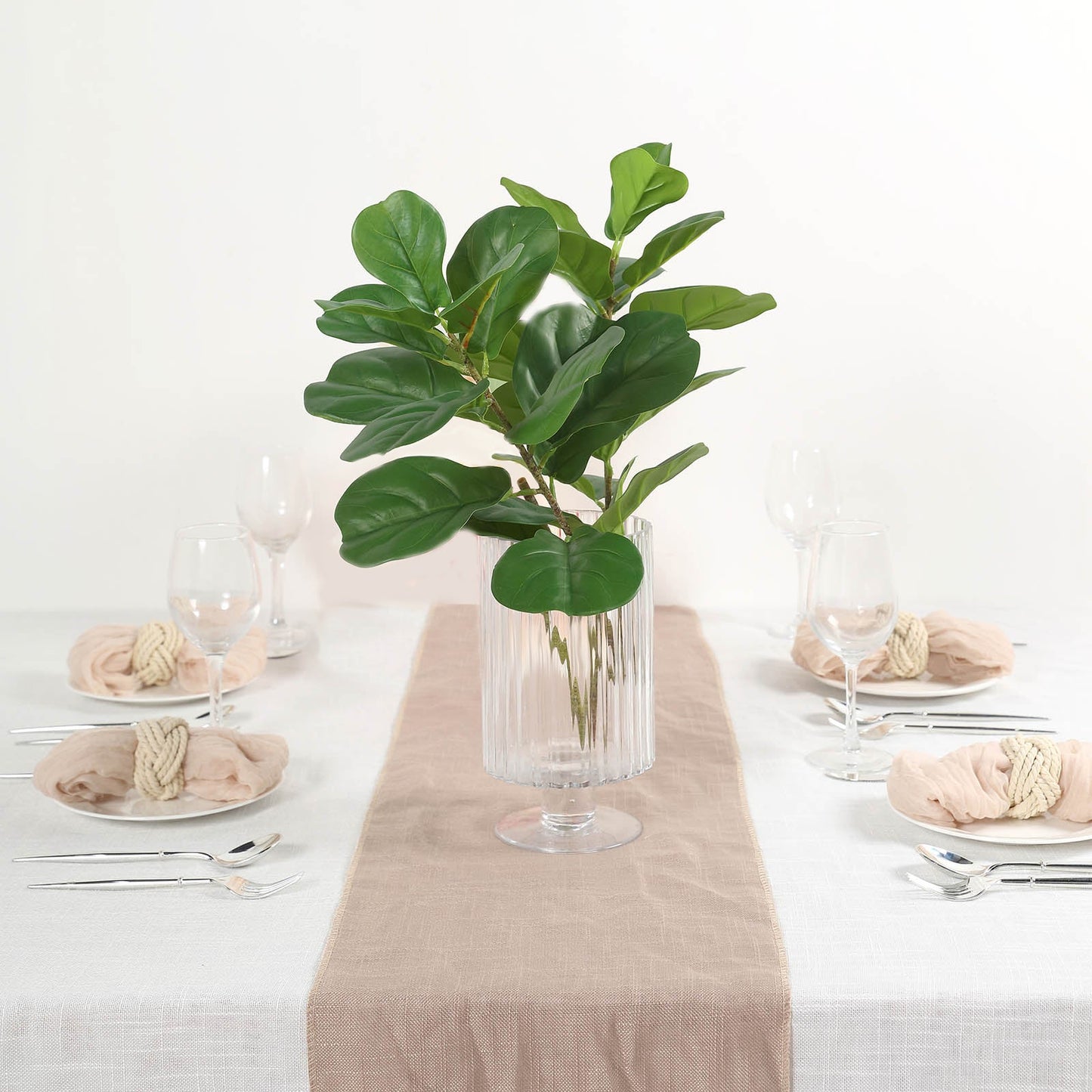 25" Green Artificial Fiddle Leaf Branch in a clear vase on a dining table.