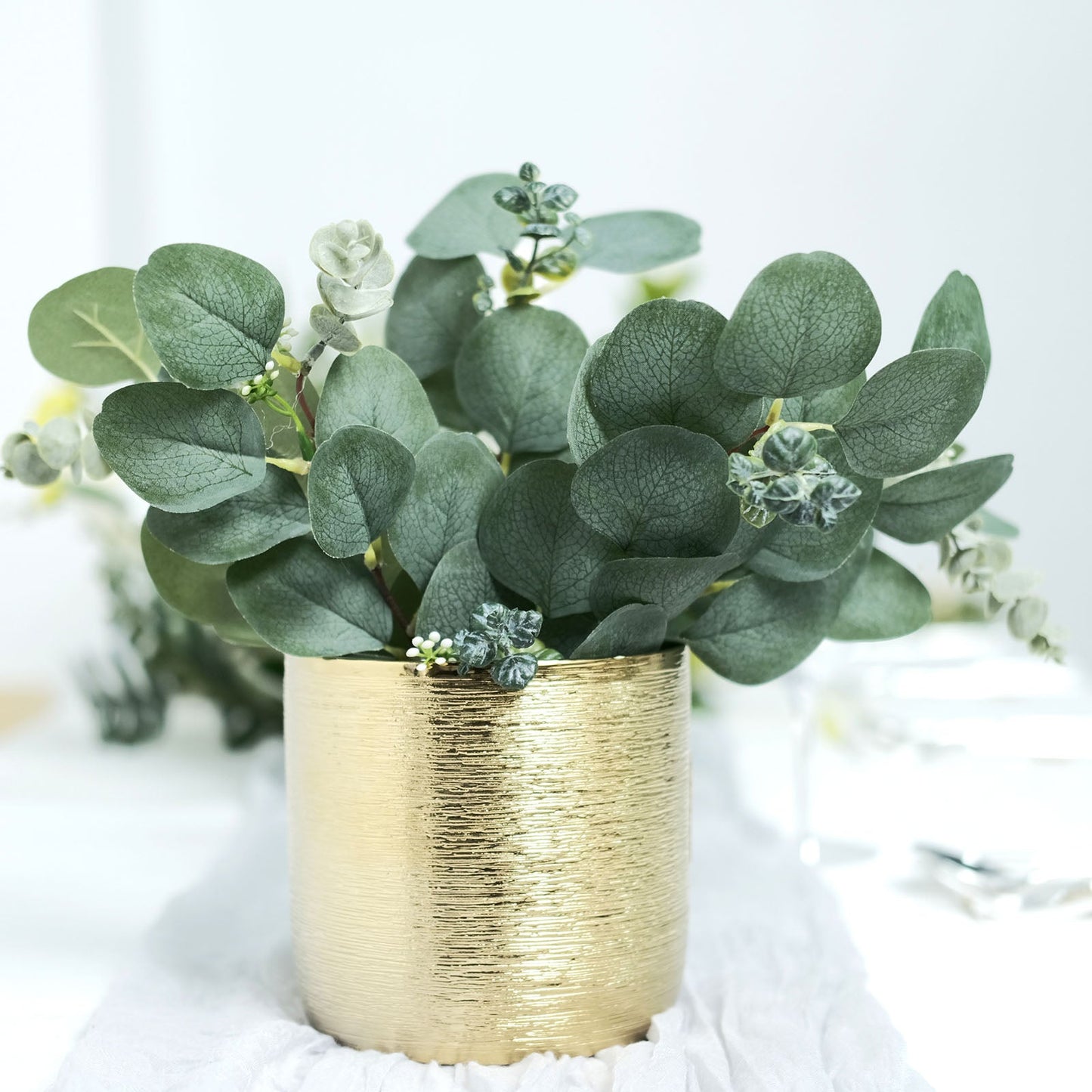 12" artificial eucalyptus leaf bouquet in a gold vase.