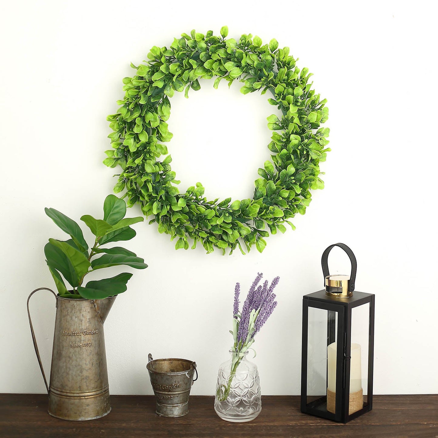 21" Green Artificial Lifelike Jasmine Leaf Spring Wreath on a wall.