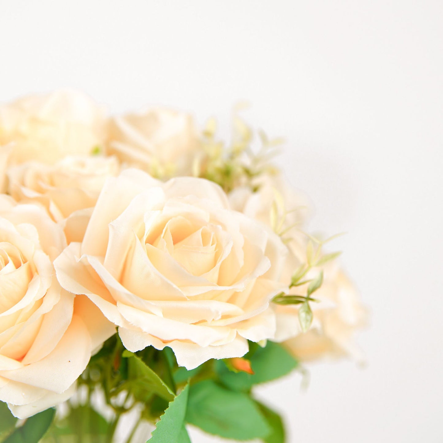 Cream artificial silk rose flower arrangement bouquet with long stems.