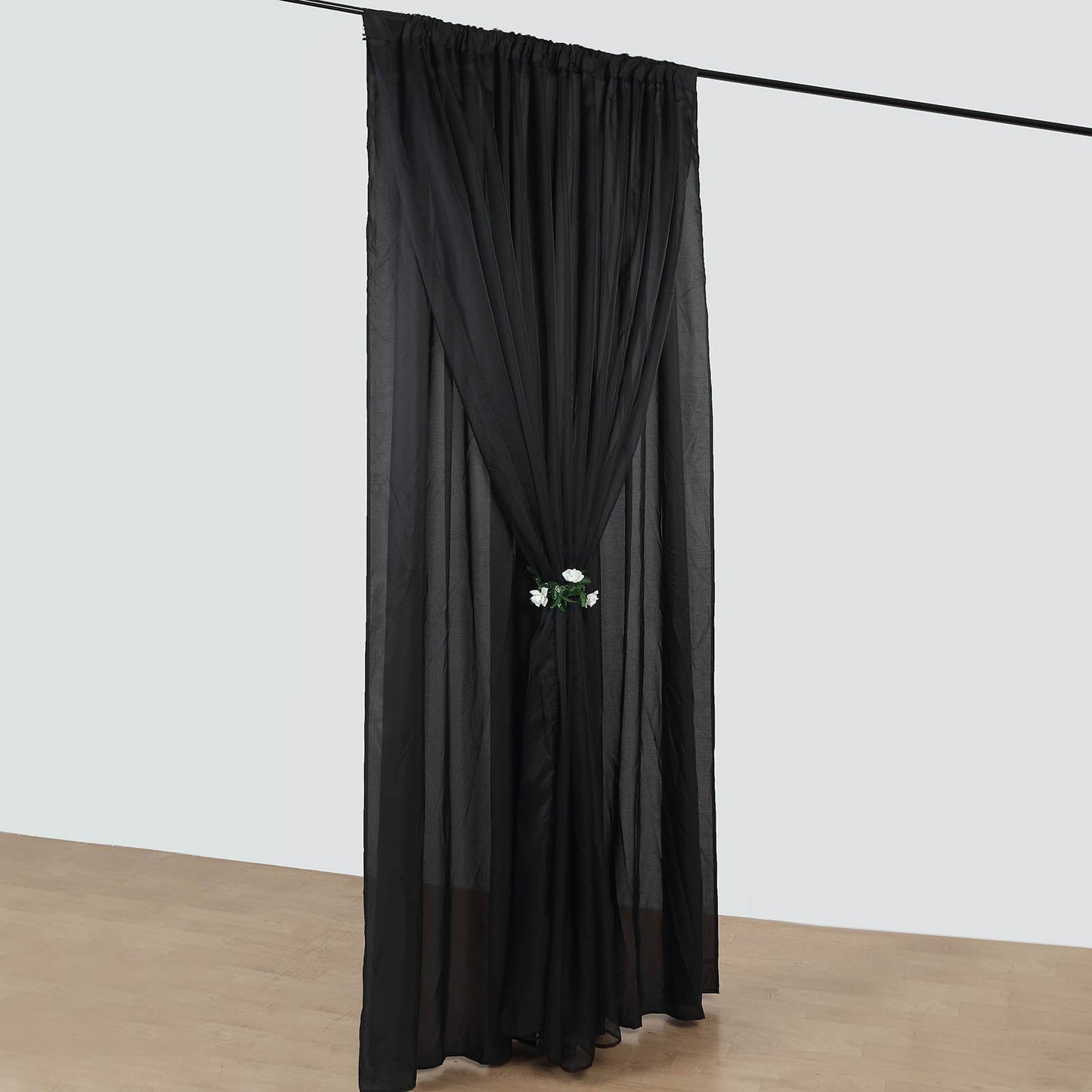 Black chiffon polyester event curtain drapes with rod pockets.