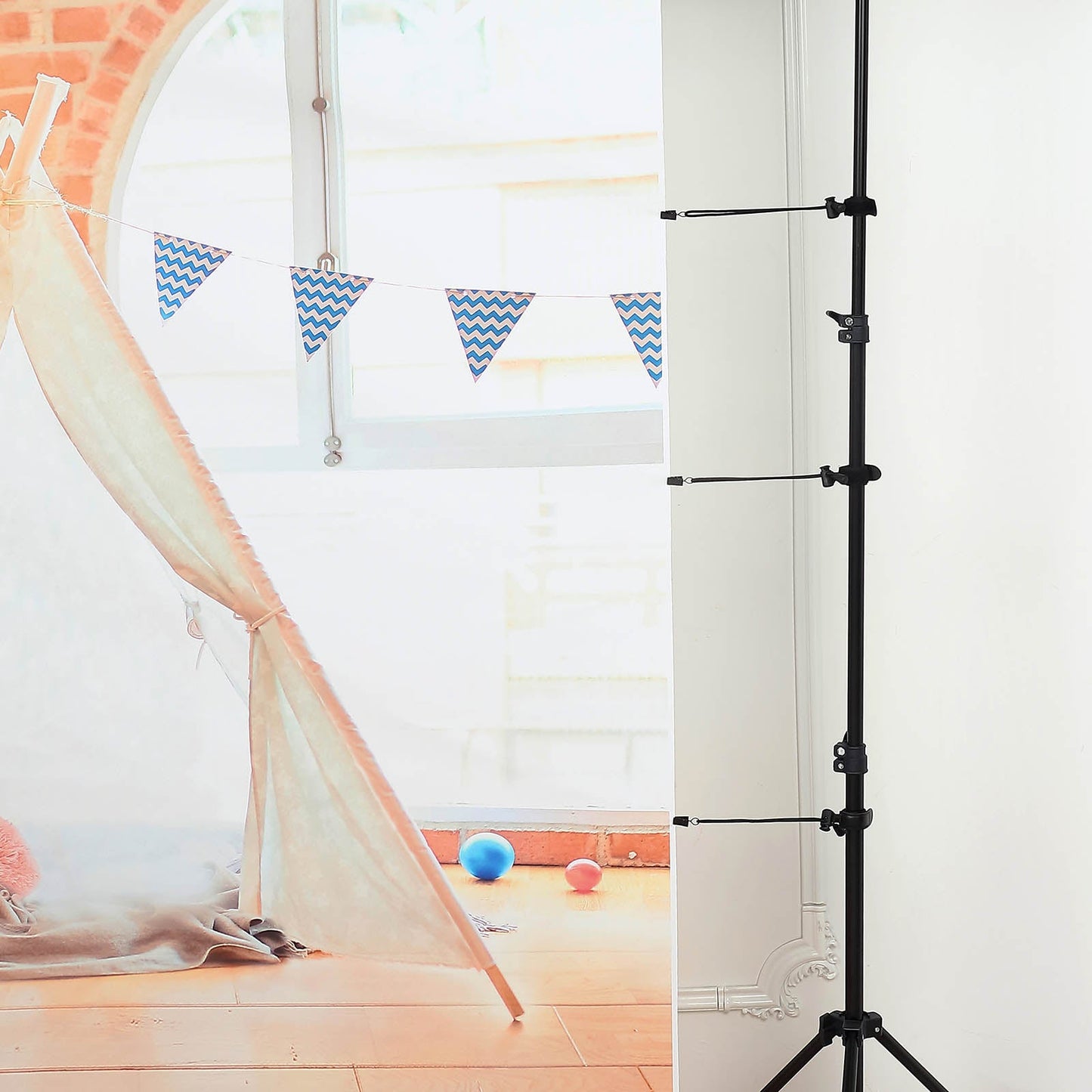 Black elastic string photography clamps with backdrop holder clips.