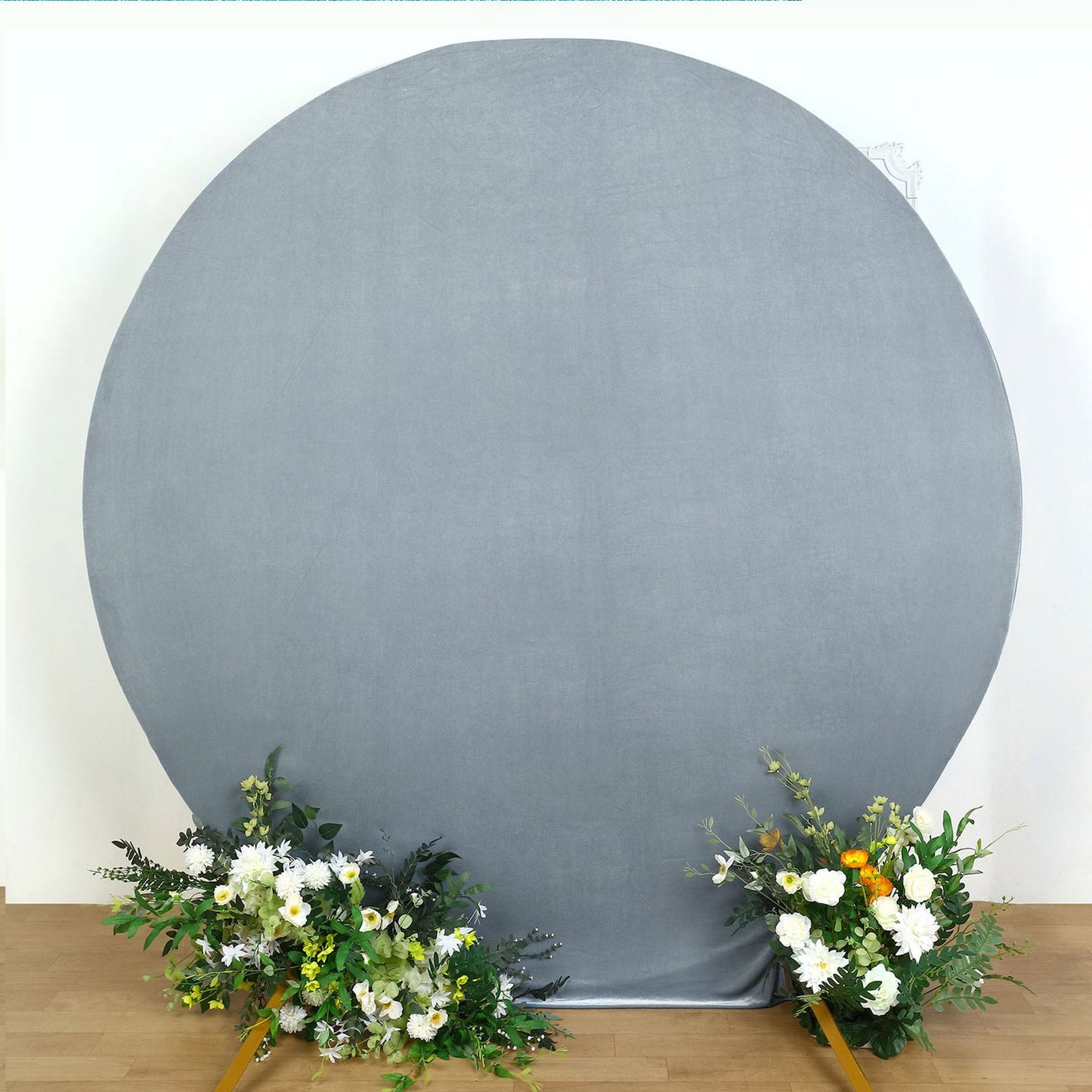 Dusty blue velvet round wedding arch cover with floral arrangements.