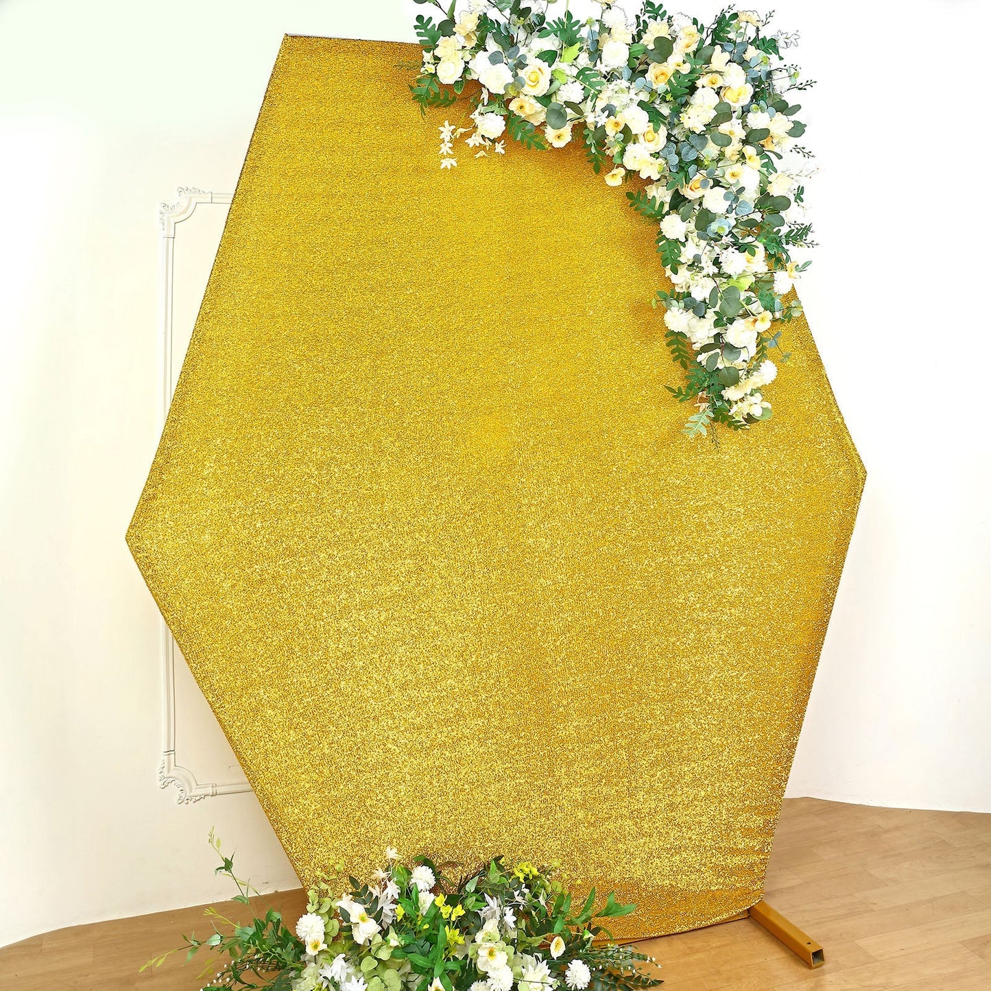 Gold metallic shimmer hexagon backdrop with floral accents.