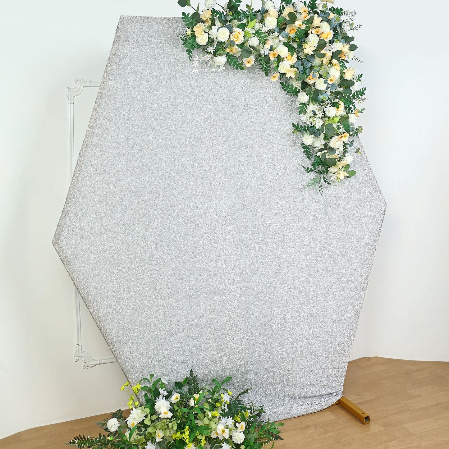 Silver metallic shimmer hexagon backdrop with floral accents.