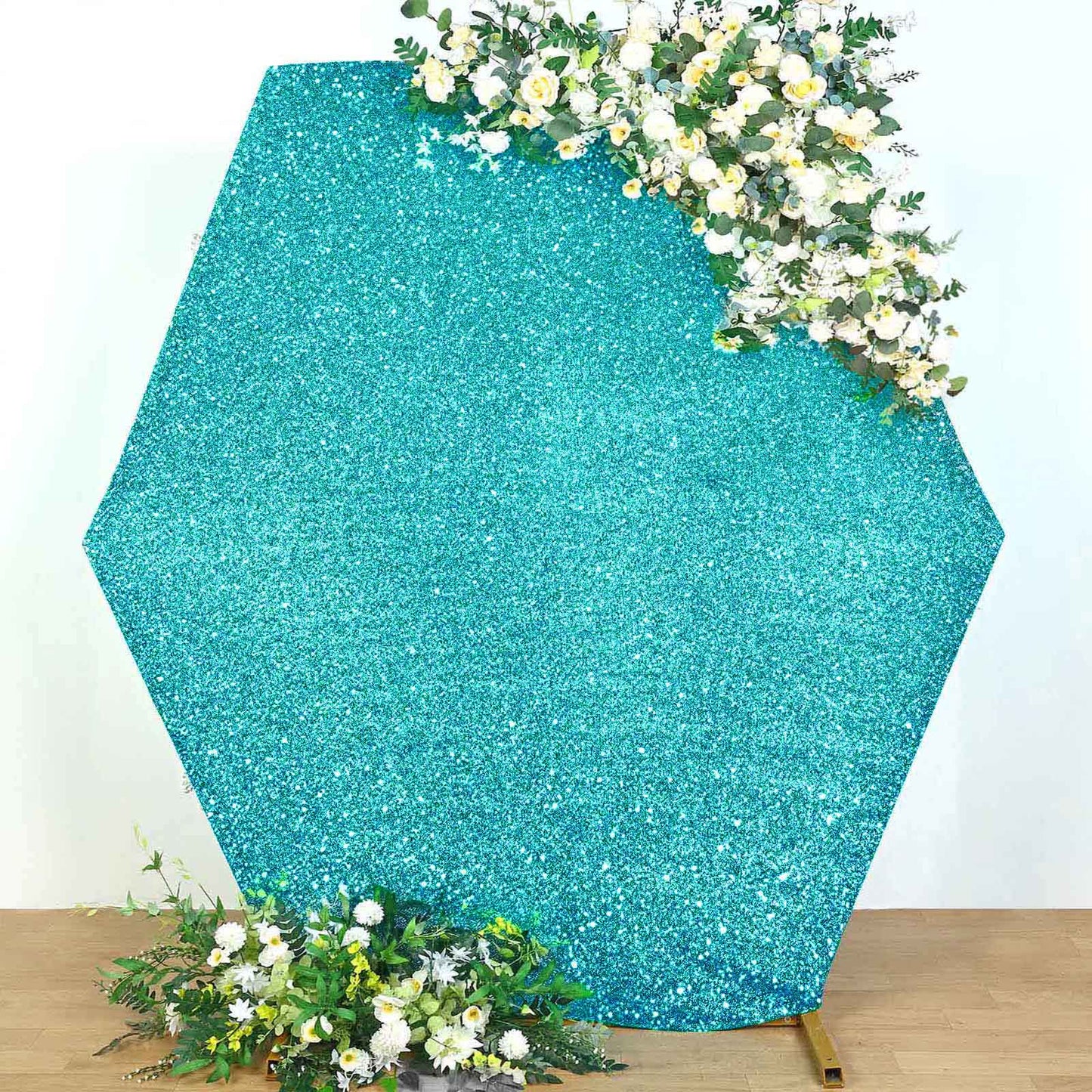 Turquoise metallic shimmer hexagon backdrop with floral accents.