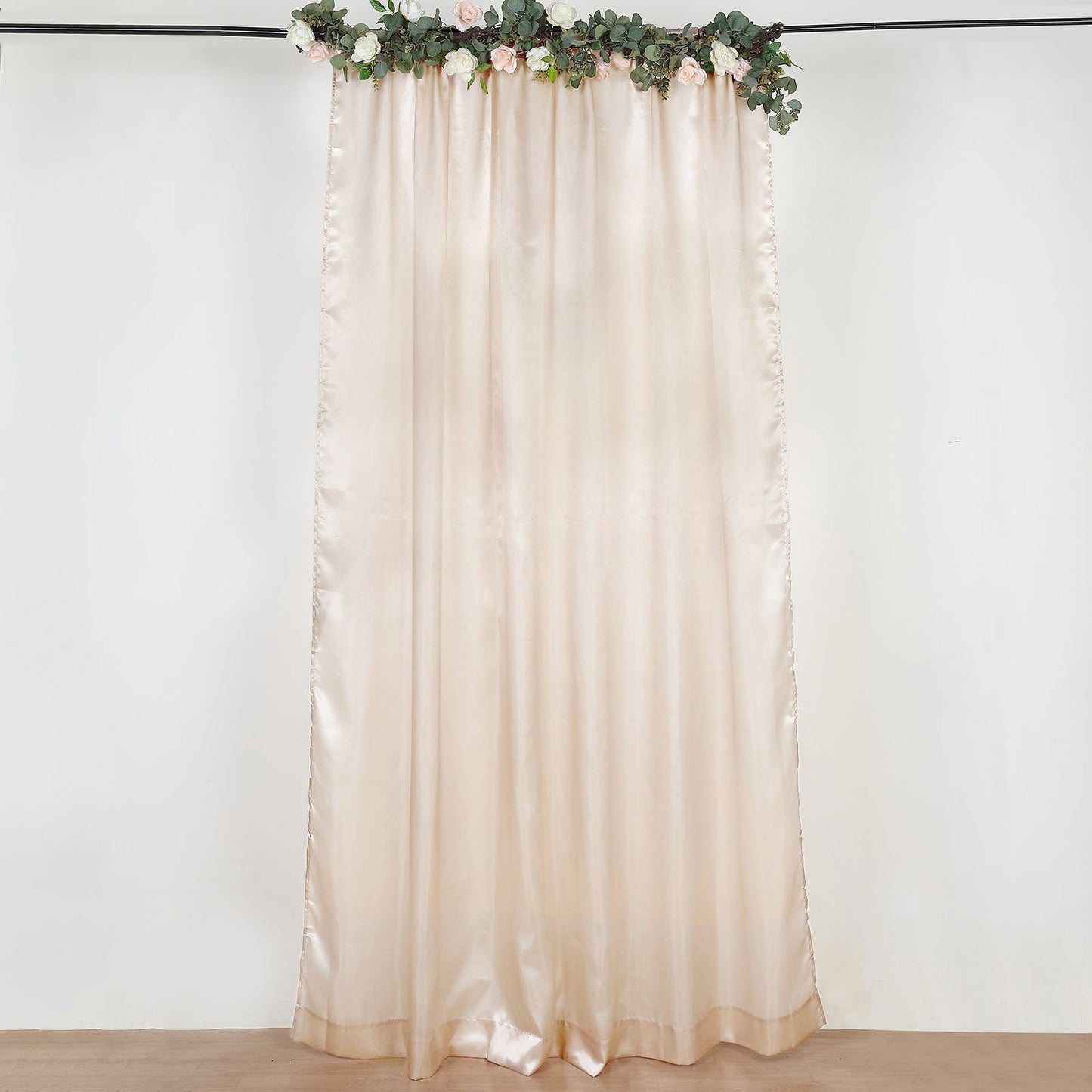 Beige satin event curtain drapes, perfect for backdrops and decorations.
