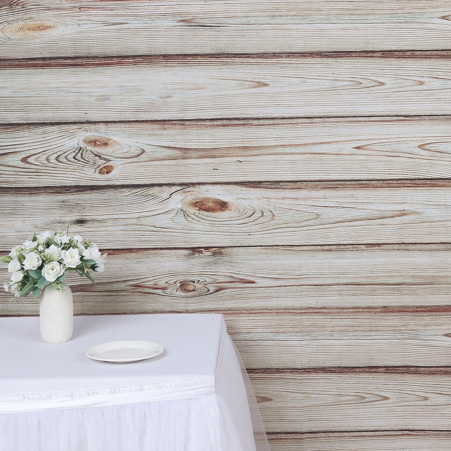 Rustic white washed wood panel photography backdrop with floral arrangement.