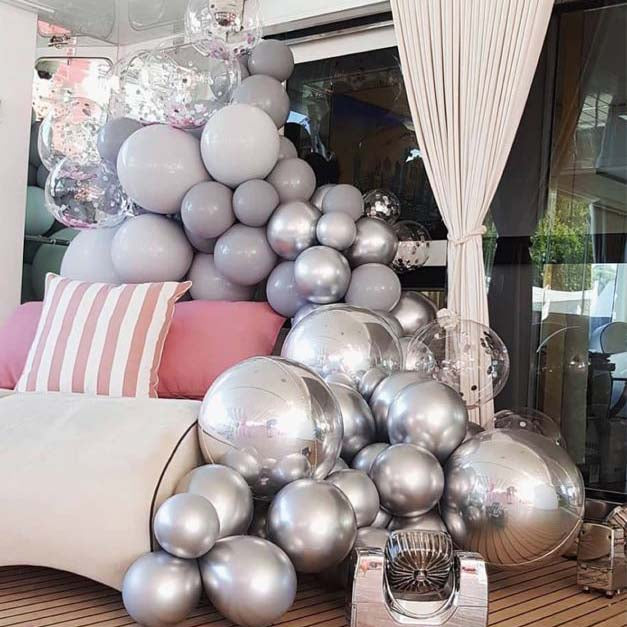 36" Giant Clear Fully Transparent PVC Bubble Balloon among silver balloons.