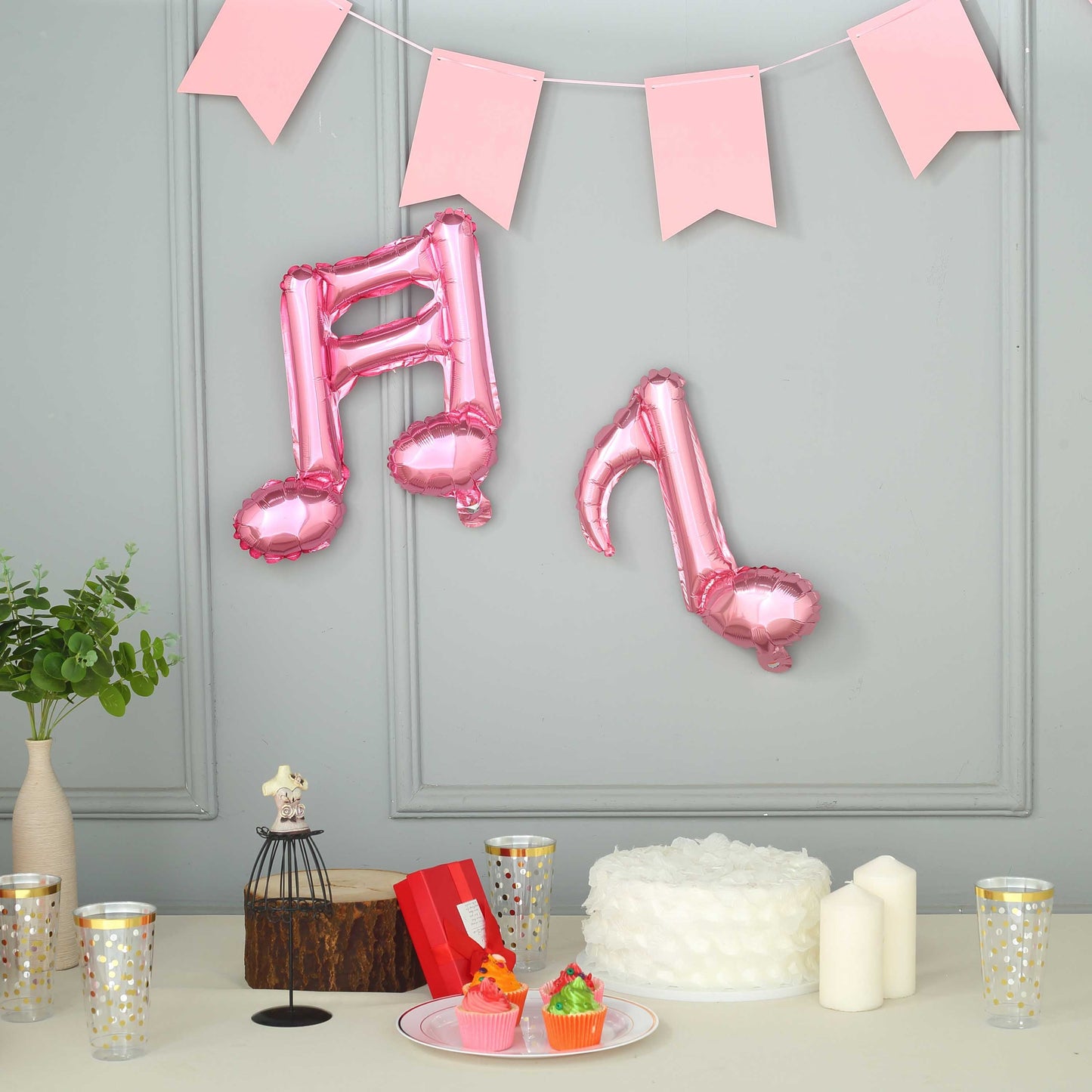 Rose gold music note mylar foil balloons in a festive setting.
