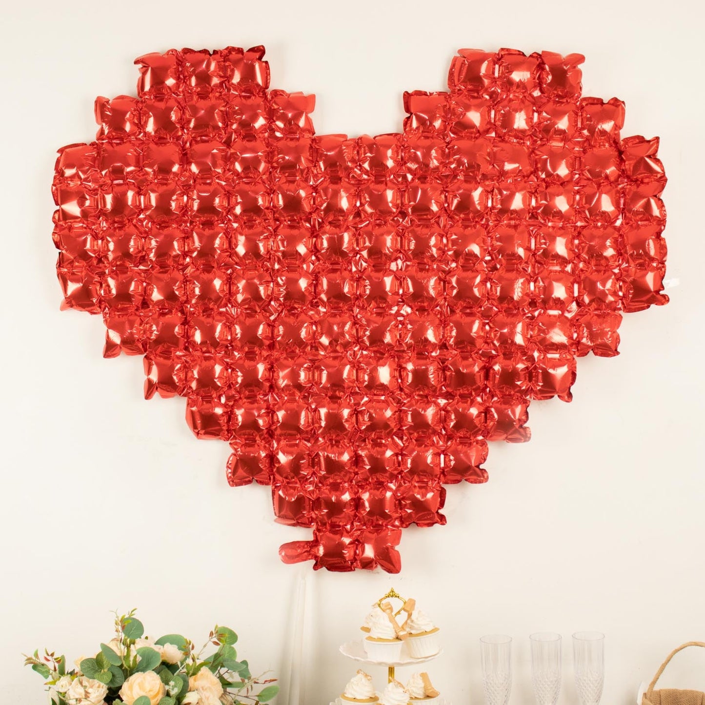 Metallic red heart-shaped mylar foil balloon backdrop for events.