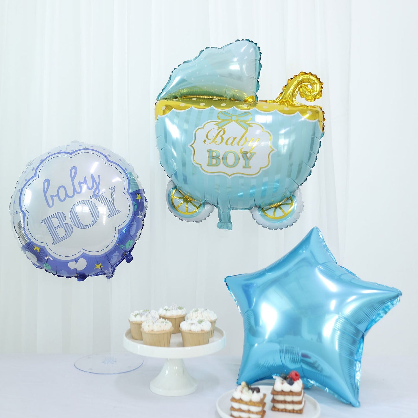 Blue and white baby shower balloon set with star and carriage designs.