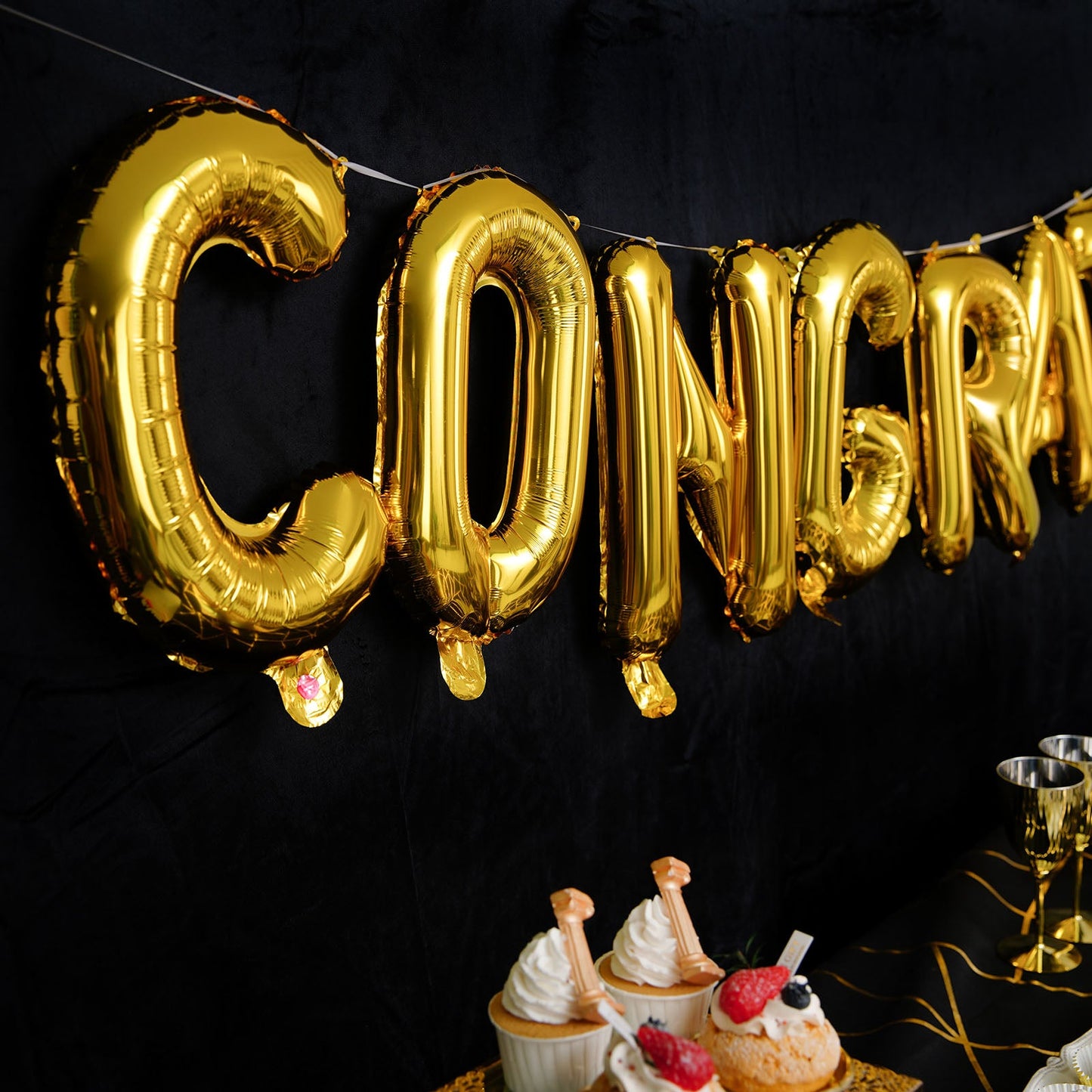 Shiny gold "Congrats" Mylar foil balloon banner decoration.