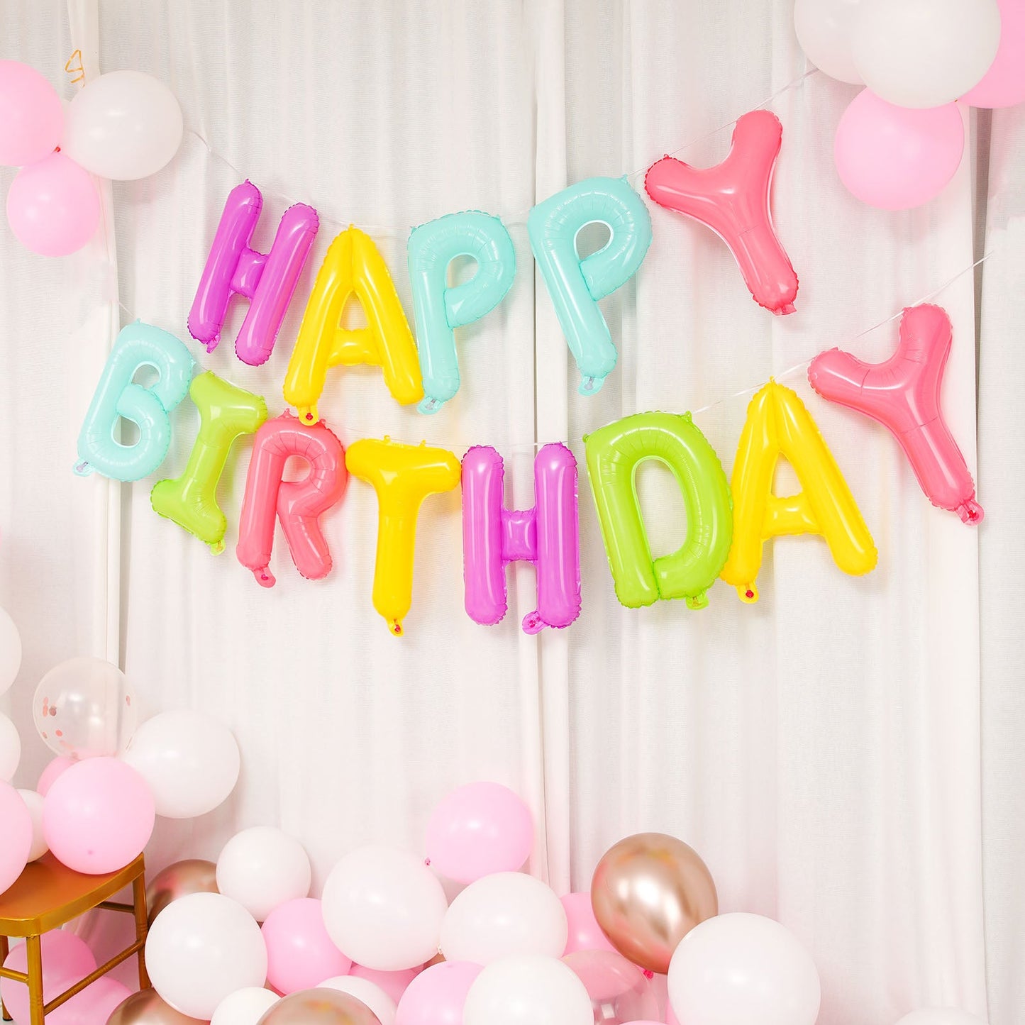 Colorful "Happy Birthday" Mylar foil balloon banner in vibrant shades.