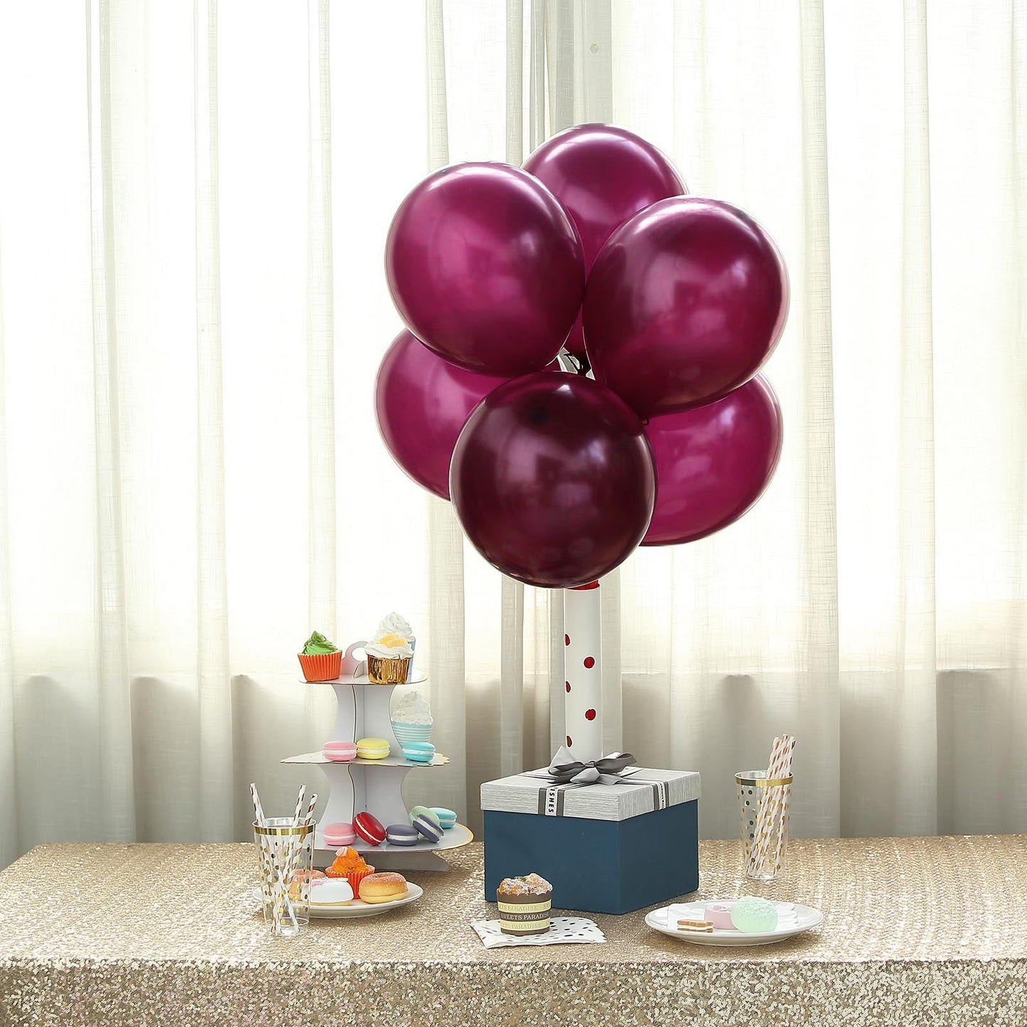 Shiny pearl eggplant balloons arranged in a decorative setting.