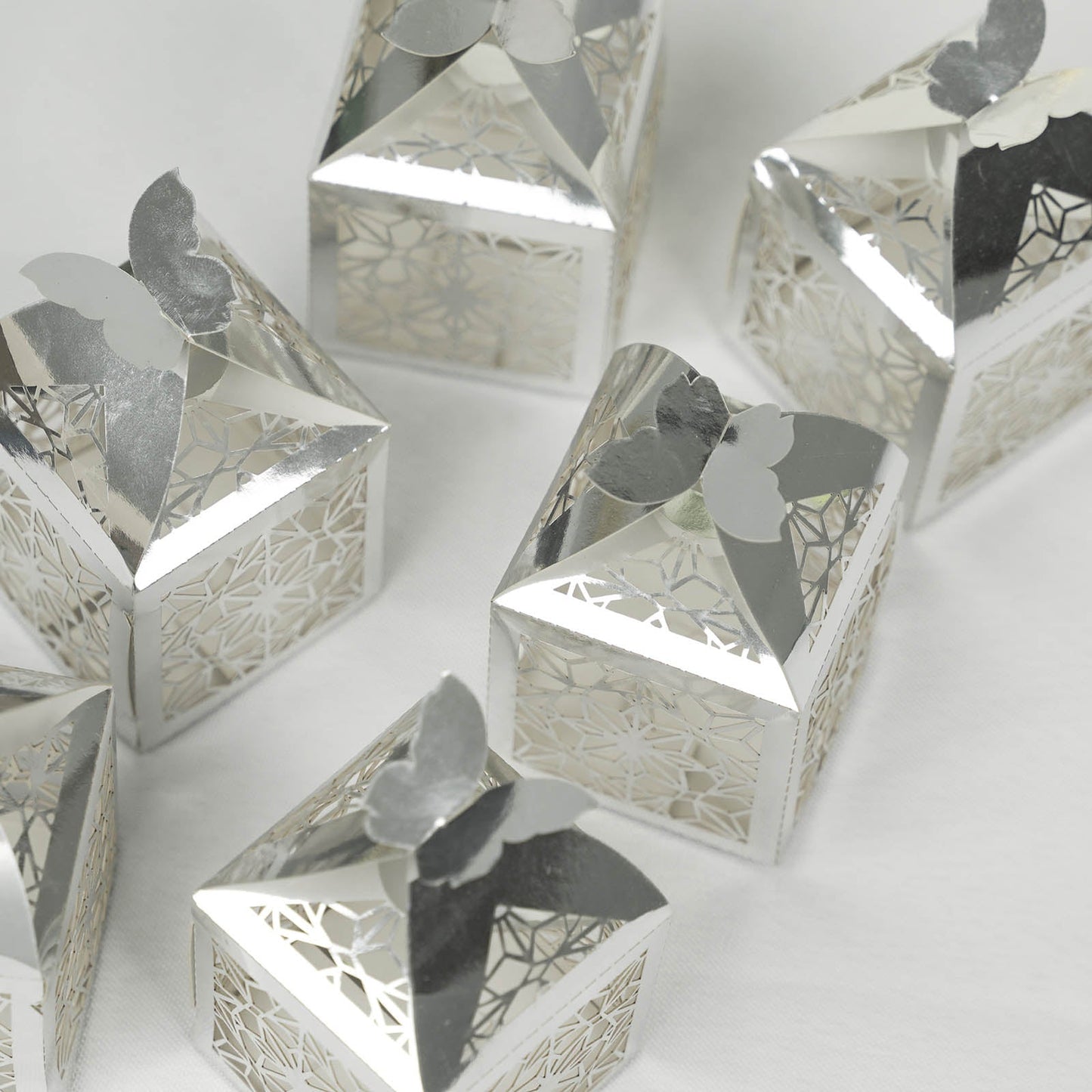 Silver butterfly top laser cut candy gift boxes, elegant party favors.