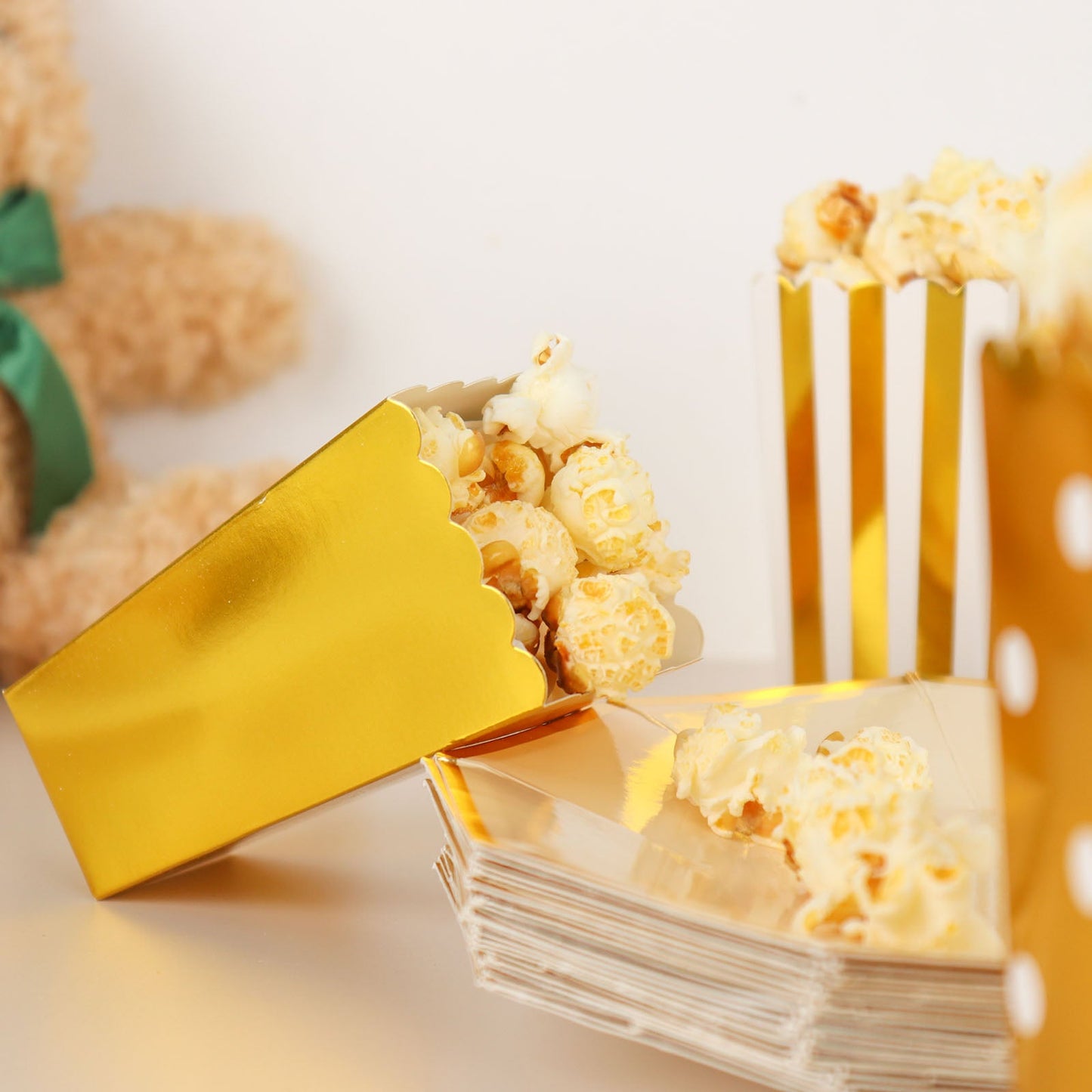 Gold popcorn favor boxes with white accents, ideal for parties and celebrations.