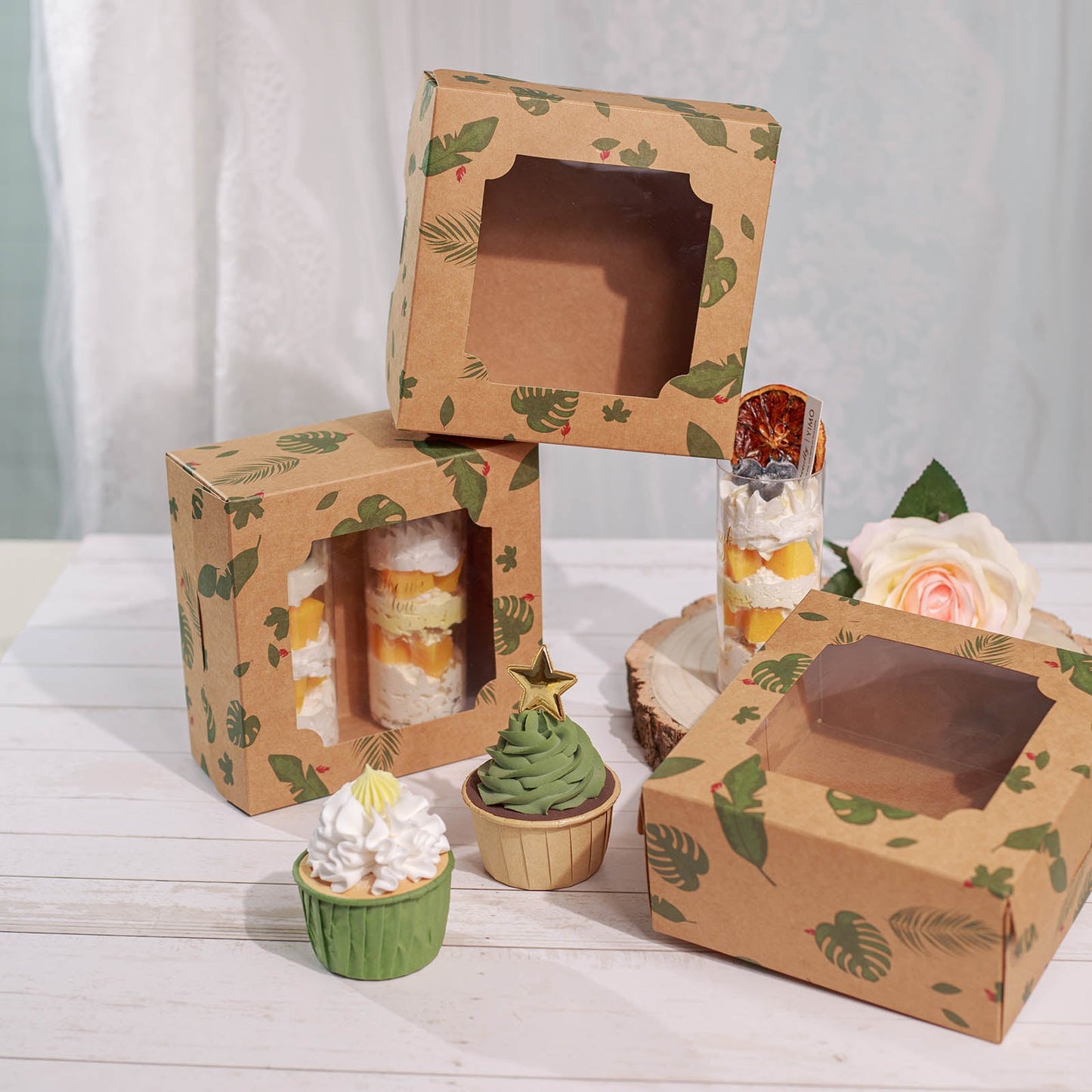 Tropical leaf bakery boxes with transparent windows, perfect for cakes and cupcakes.