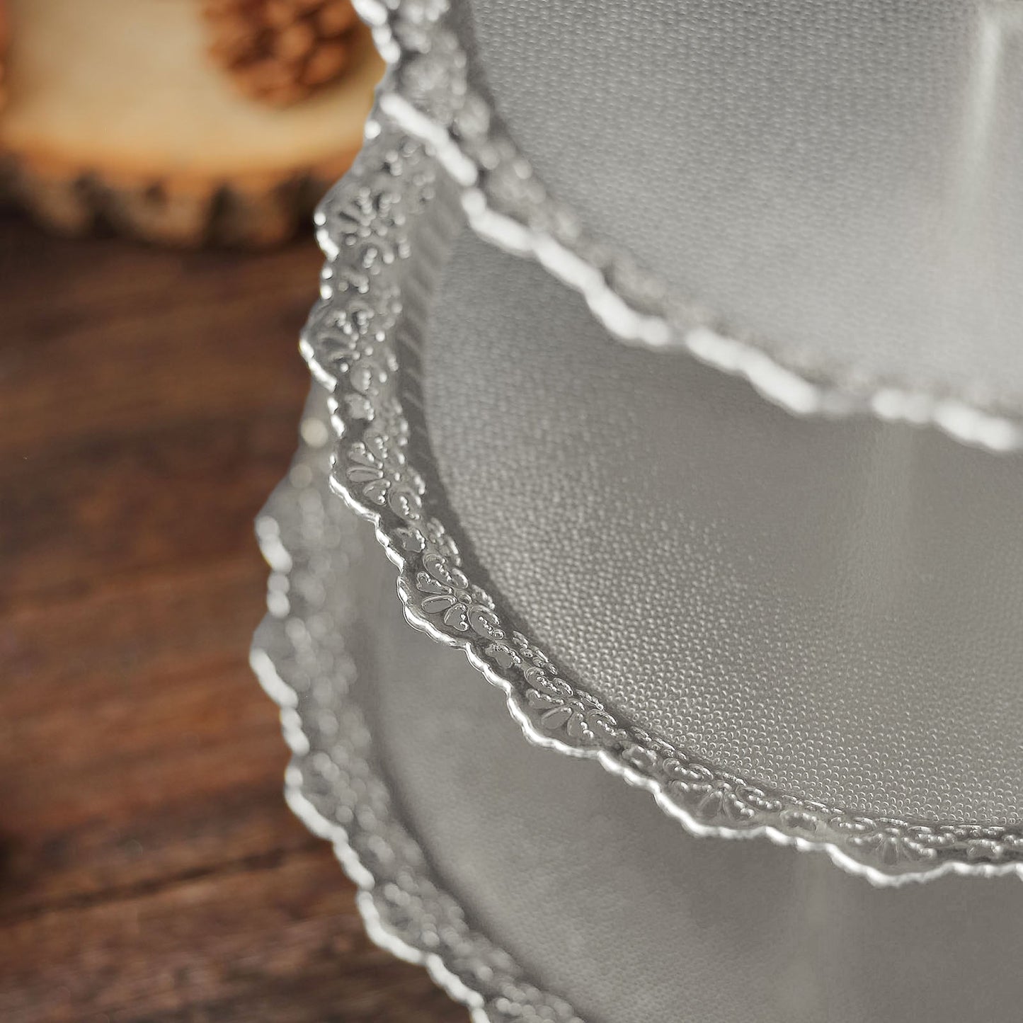 Metallic silver 3-tier round cupcake stand with lace cut edges.
