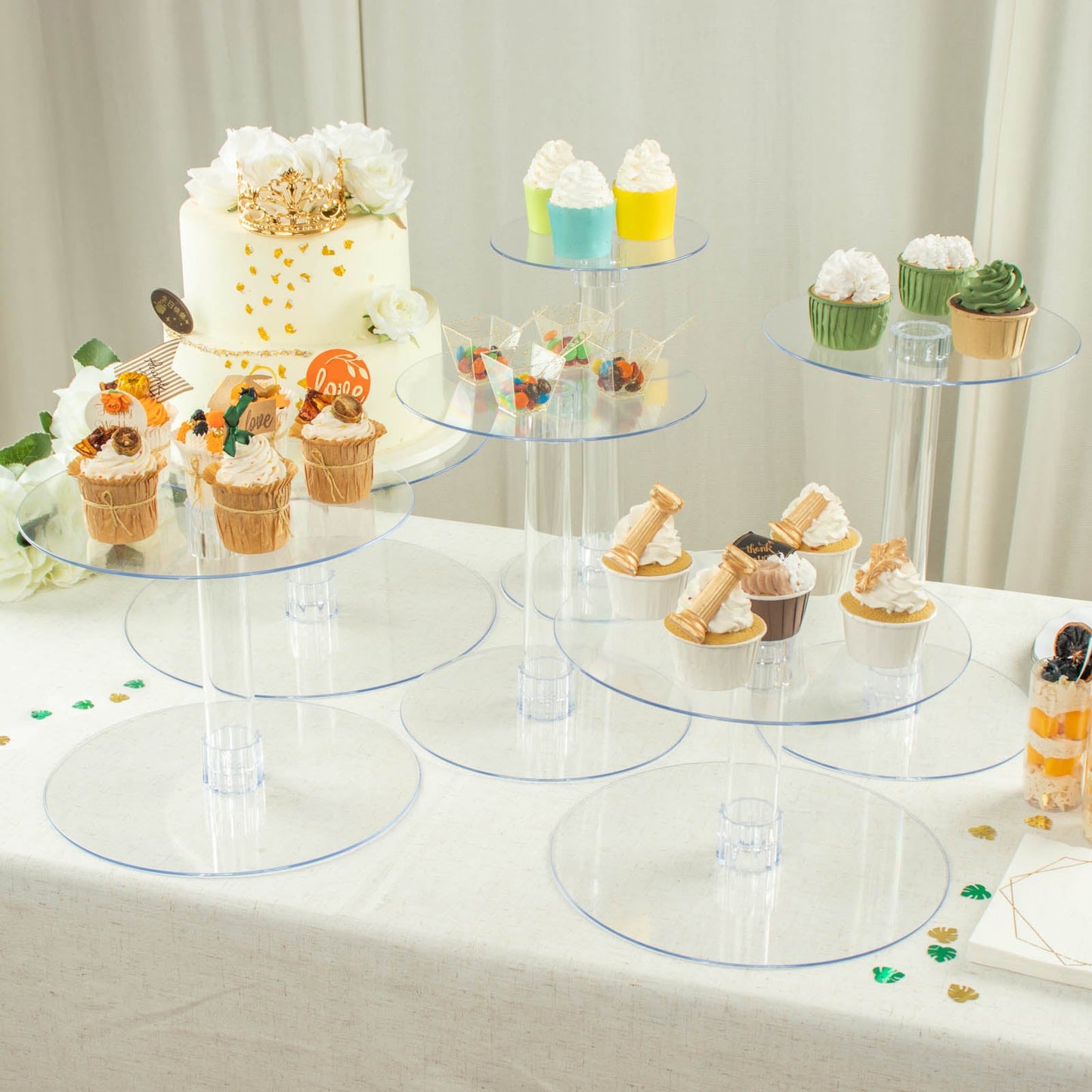 Clear acrylic cake stand set with cupcakes and desserts.