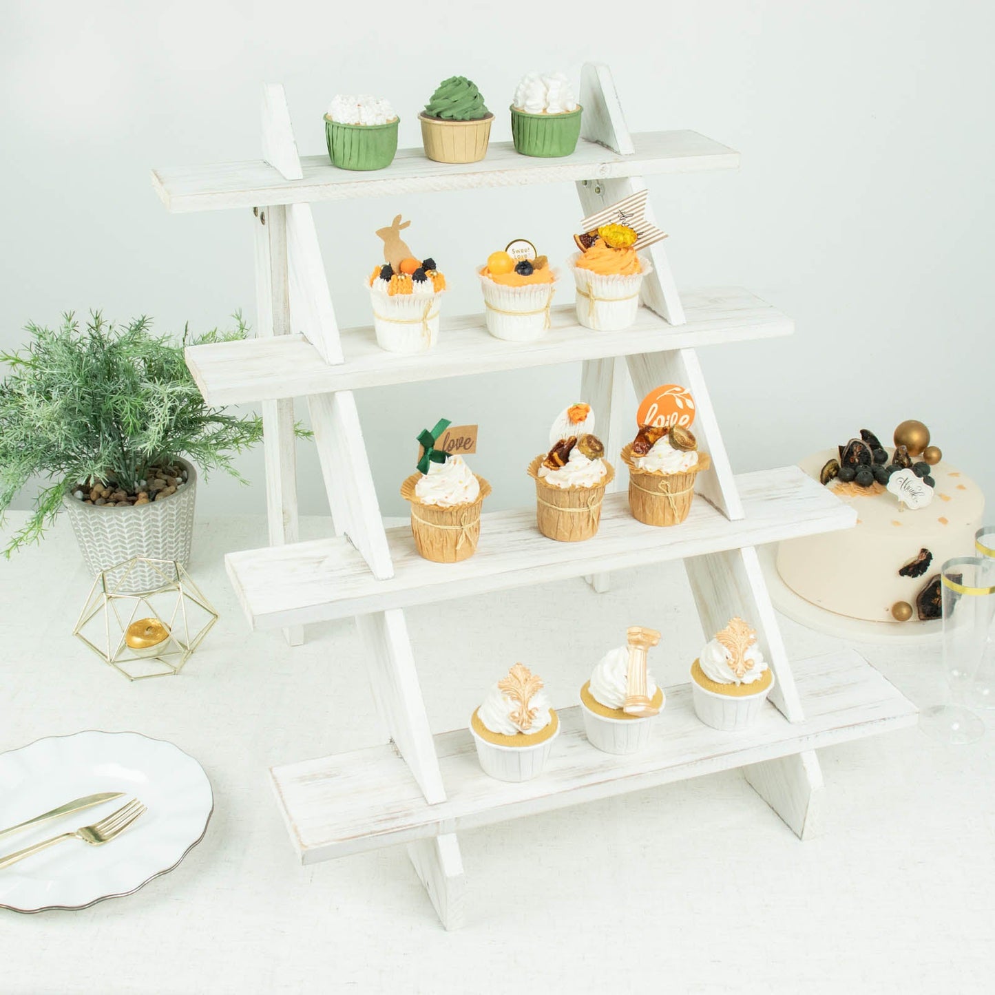 Rustic whitewashed 4-tier wooden ladder shelf dessert display with cupcakes.