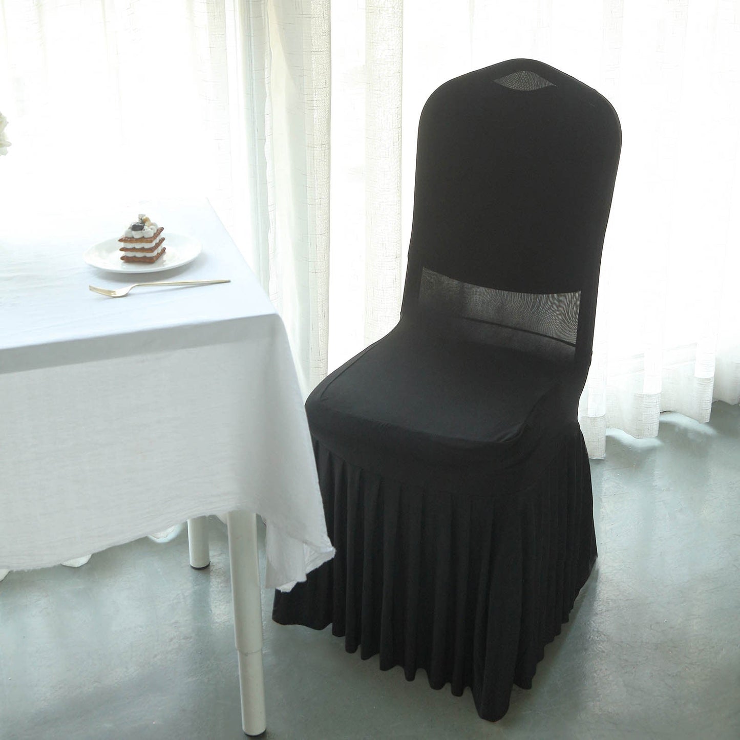 Black ruffle pleated spandex chair slipcover for banquet settings.