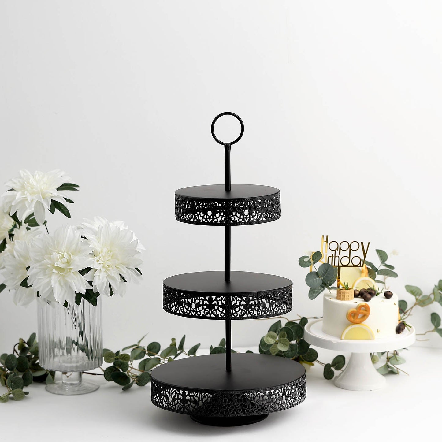 Black metal 3-tier cupcake stand with decorative edges, perfect for desserts.
