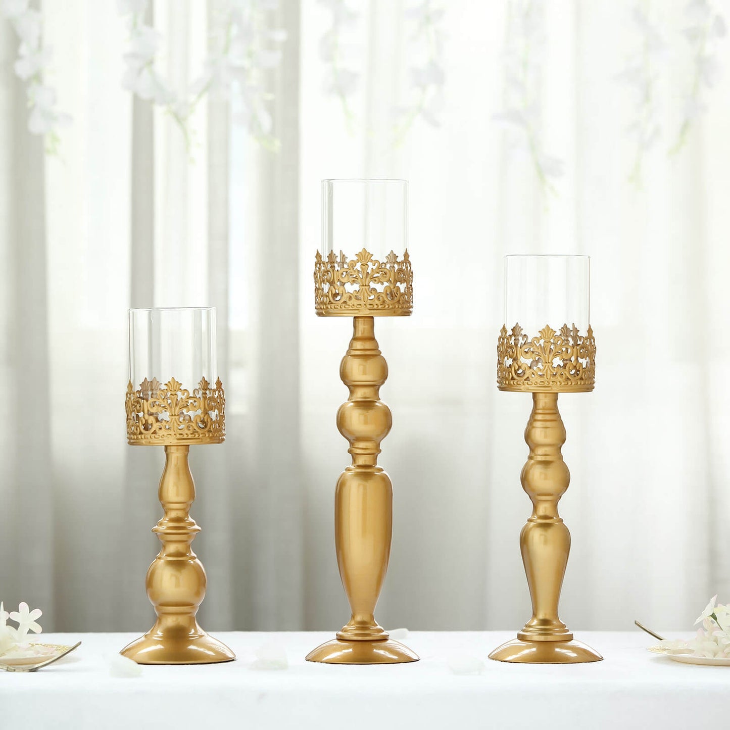 Antique gold lace hurricane candle holders set of 3 in varying heights.