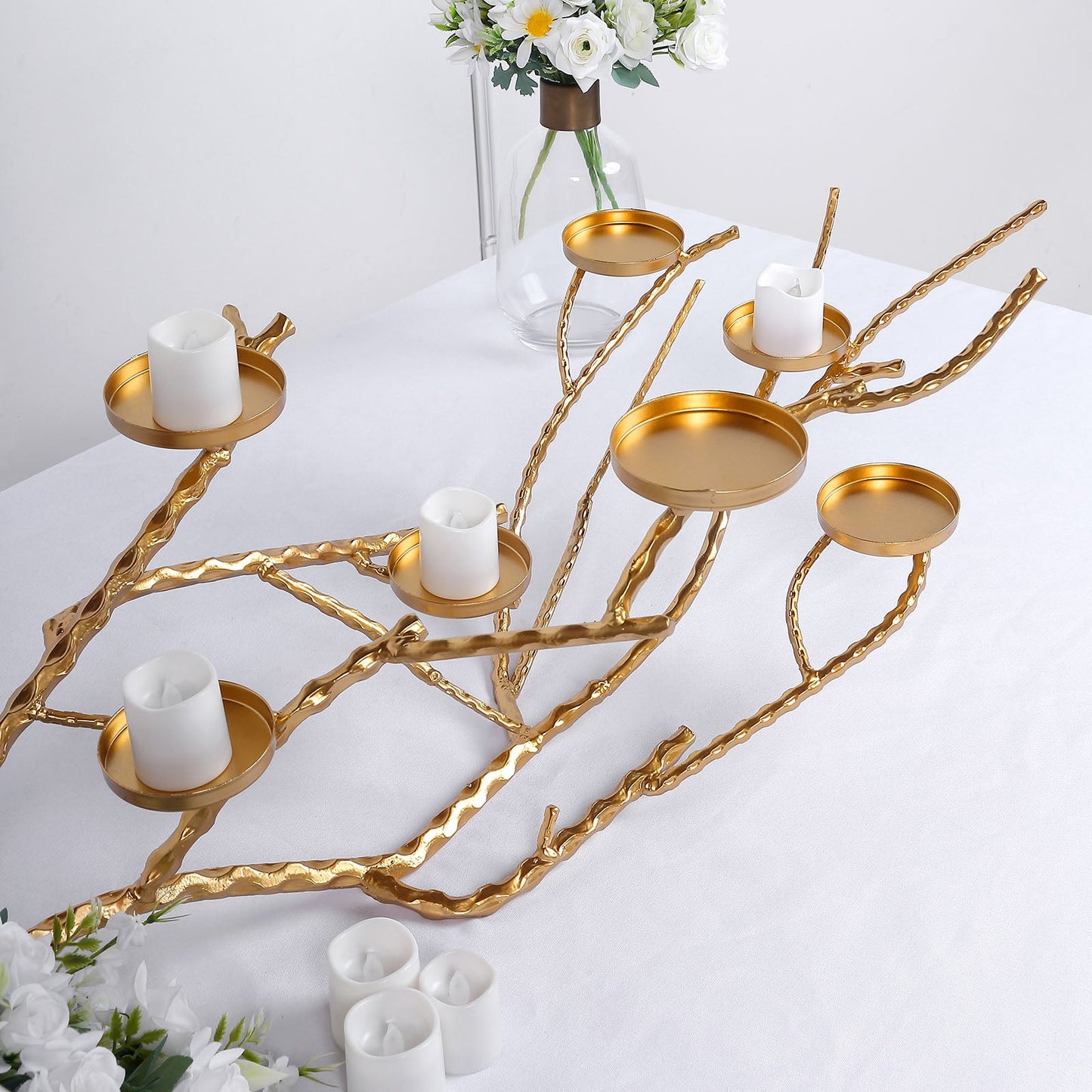 Gold Manzanita tree branch candelabra candle holder stand with white candles.