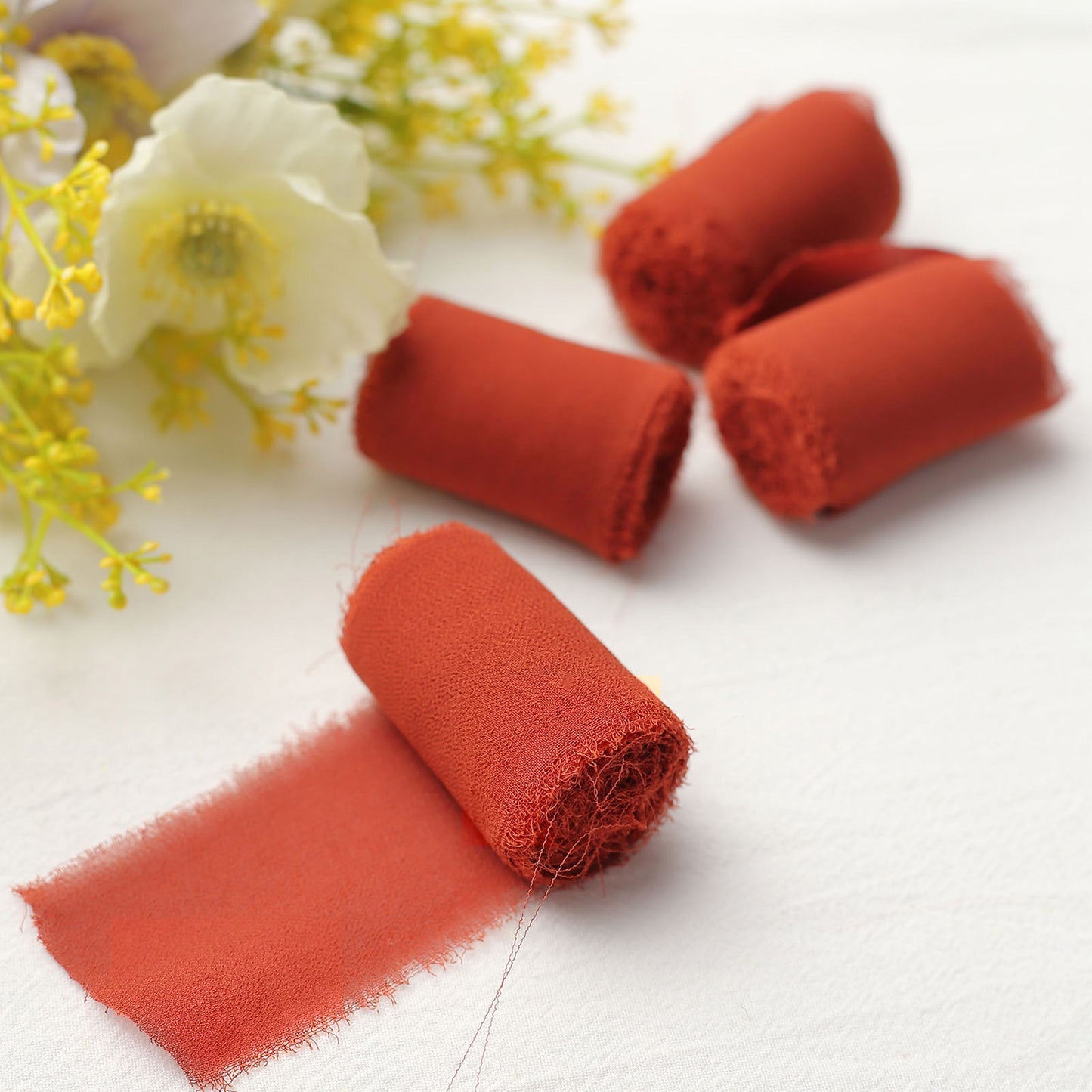 Terracotta silk-like chiffon ribbon roll for DIY wedding bouquets.