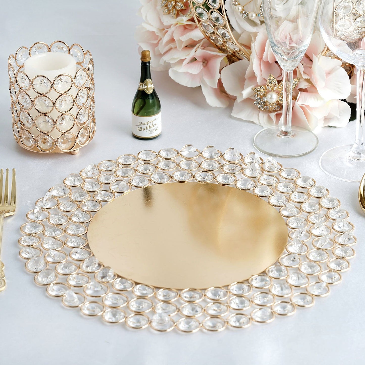 Gold beaded charger plate with acrylic crystals and metal accents.