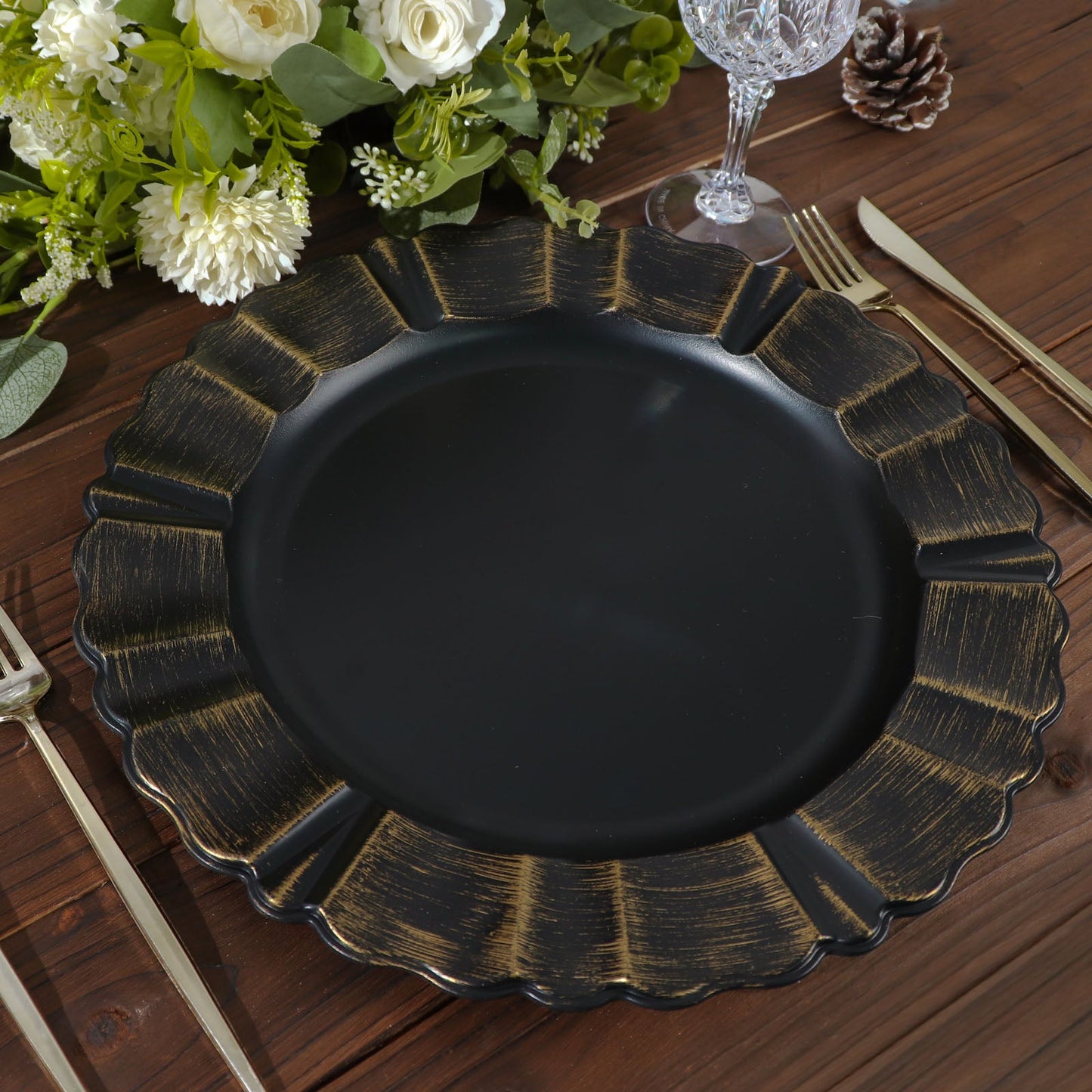 13" round matte black acrylic charger plate with gold brushed wavy scalloped rim.