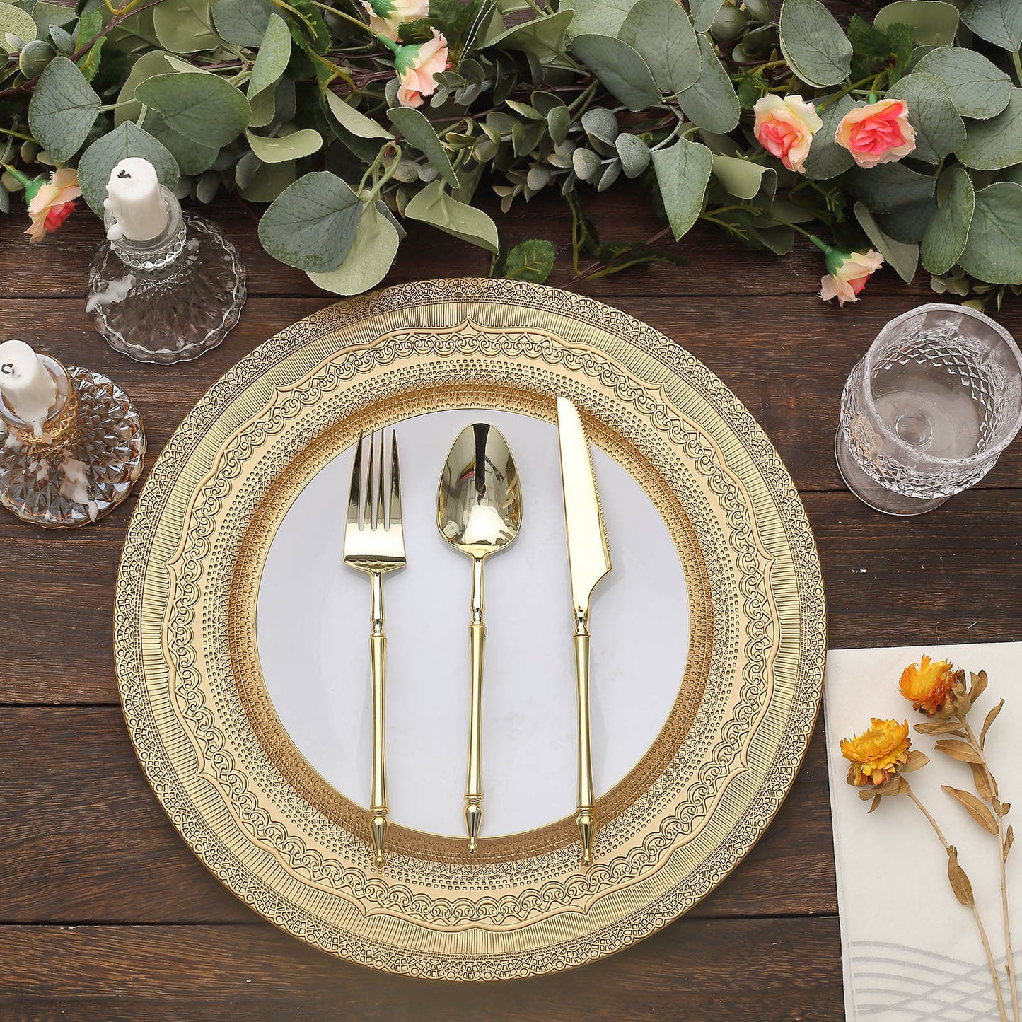 Gold rustic lace embossed acrylic plastic charger plates on a wooden table setting.