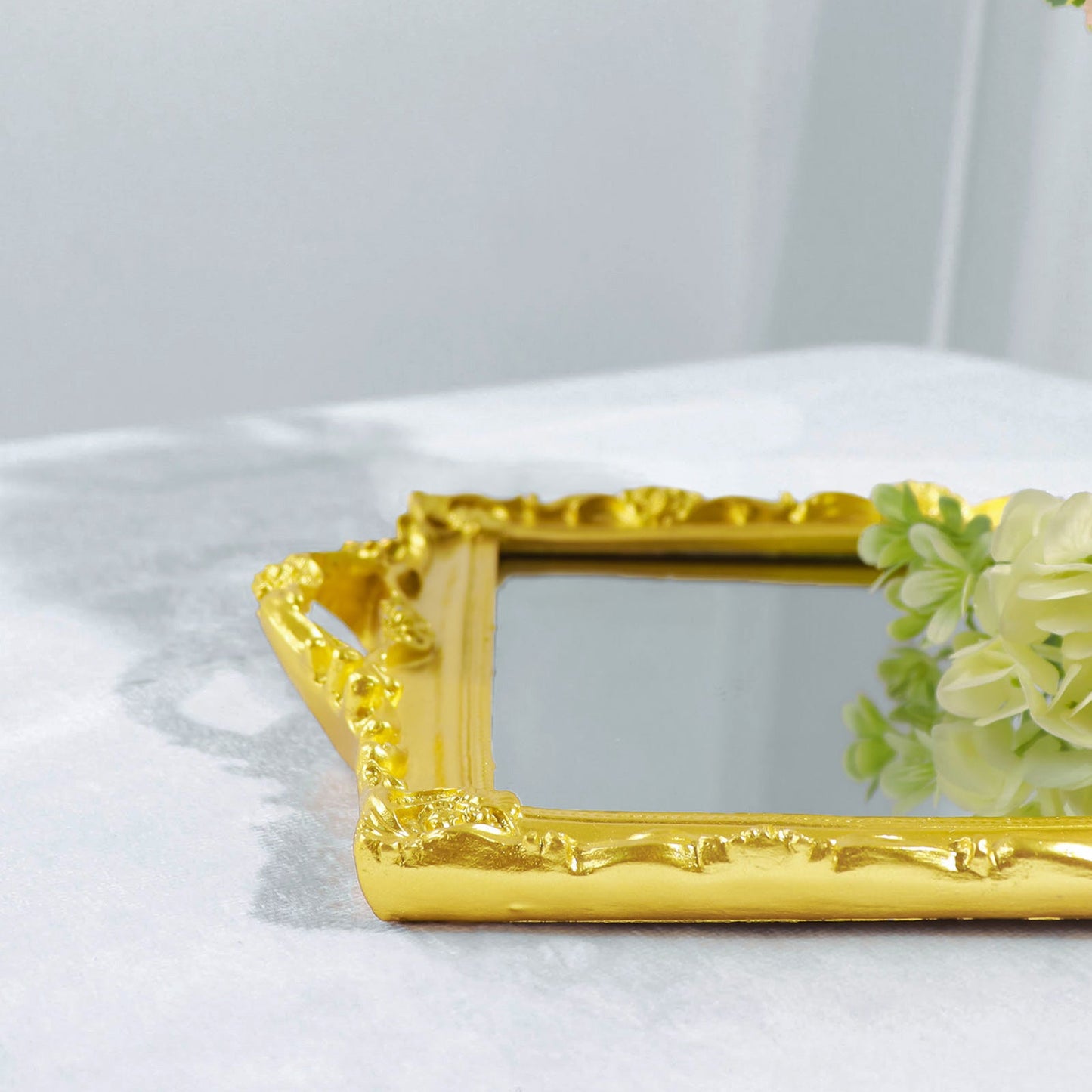 Metallic gold decorative vanity serving tray with mirrored surface.