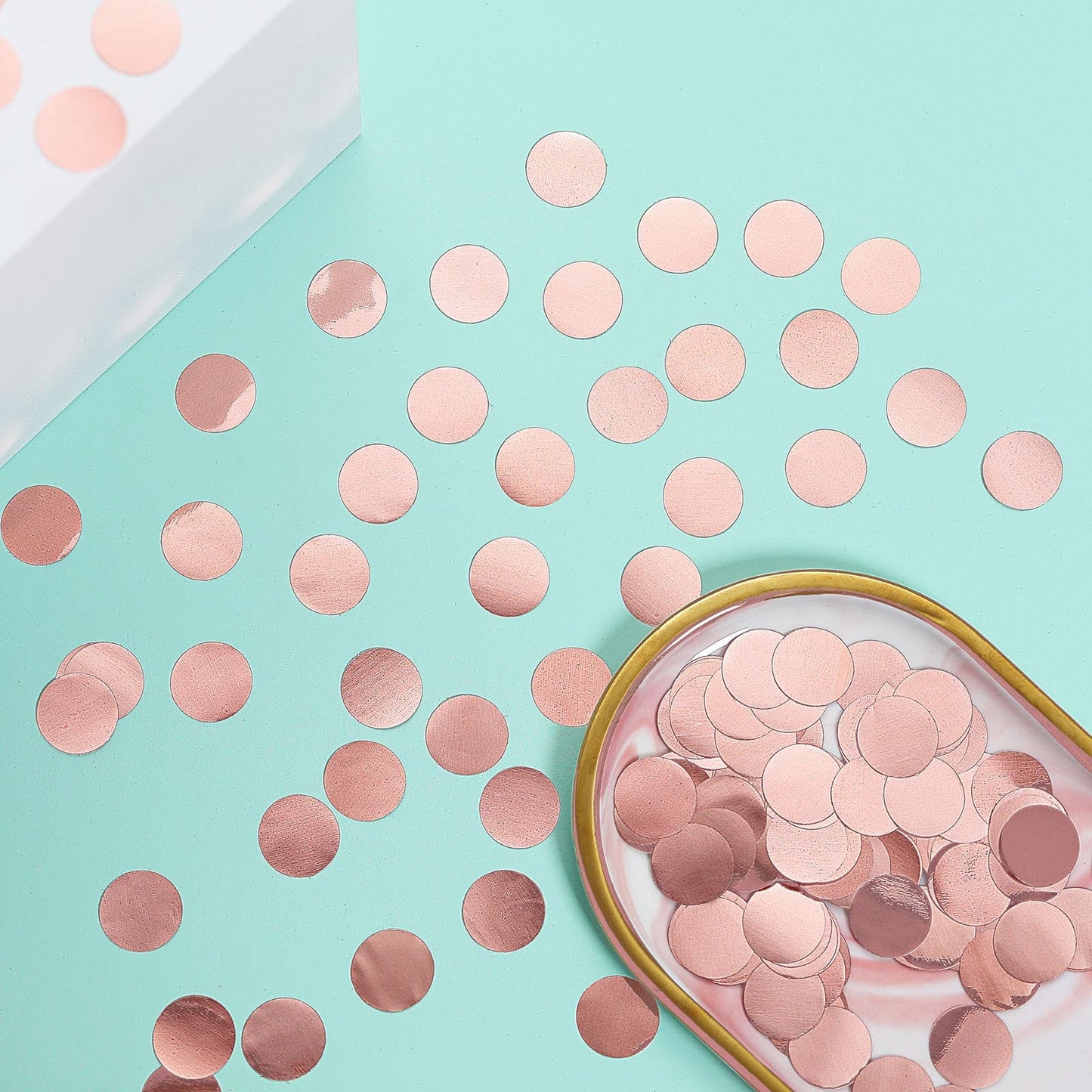 Rose gold round foil confetti dots on a mint background.
