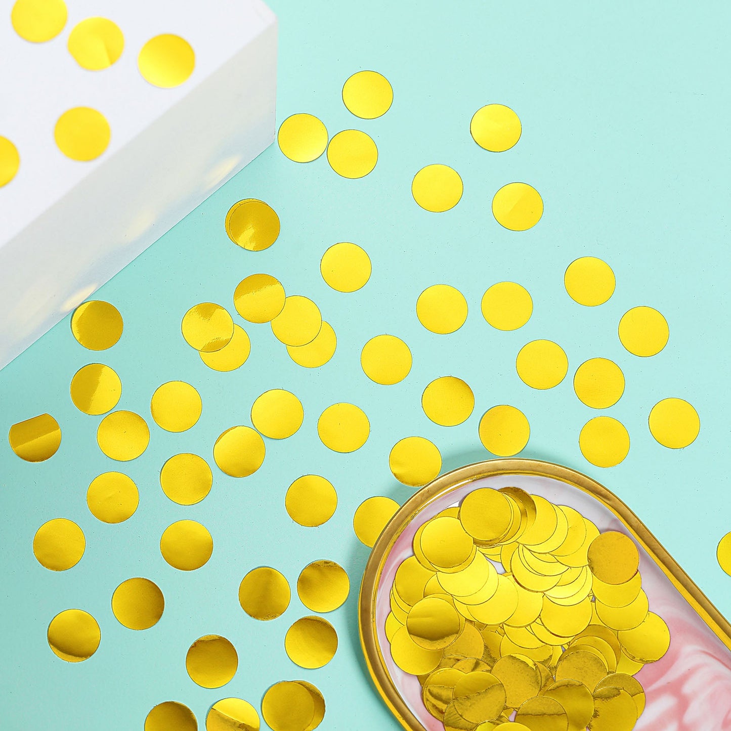Gold round foil metallic table confetti dots on a teal background.