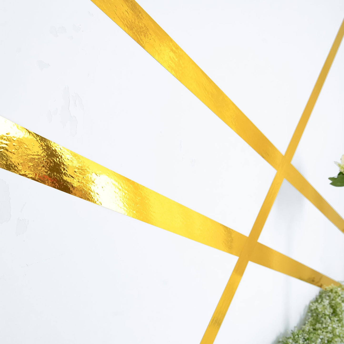 Gold metallic film tape on a white background, ideal for DIY crafts and decor.