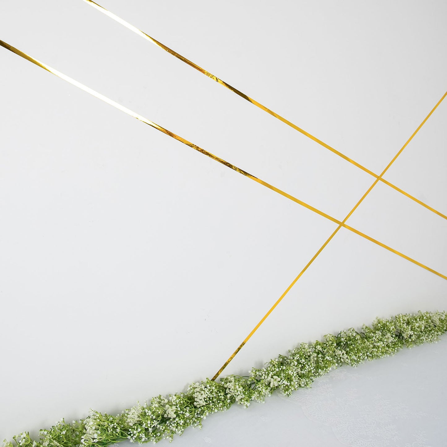 Gold metallic film tape on a floral backdrop.