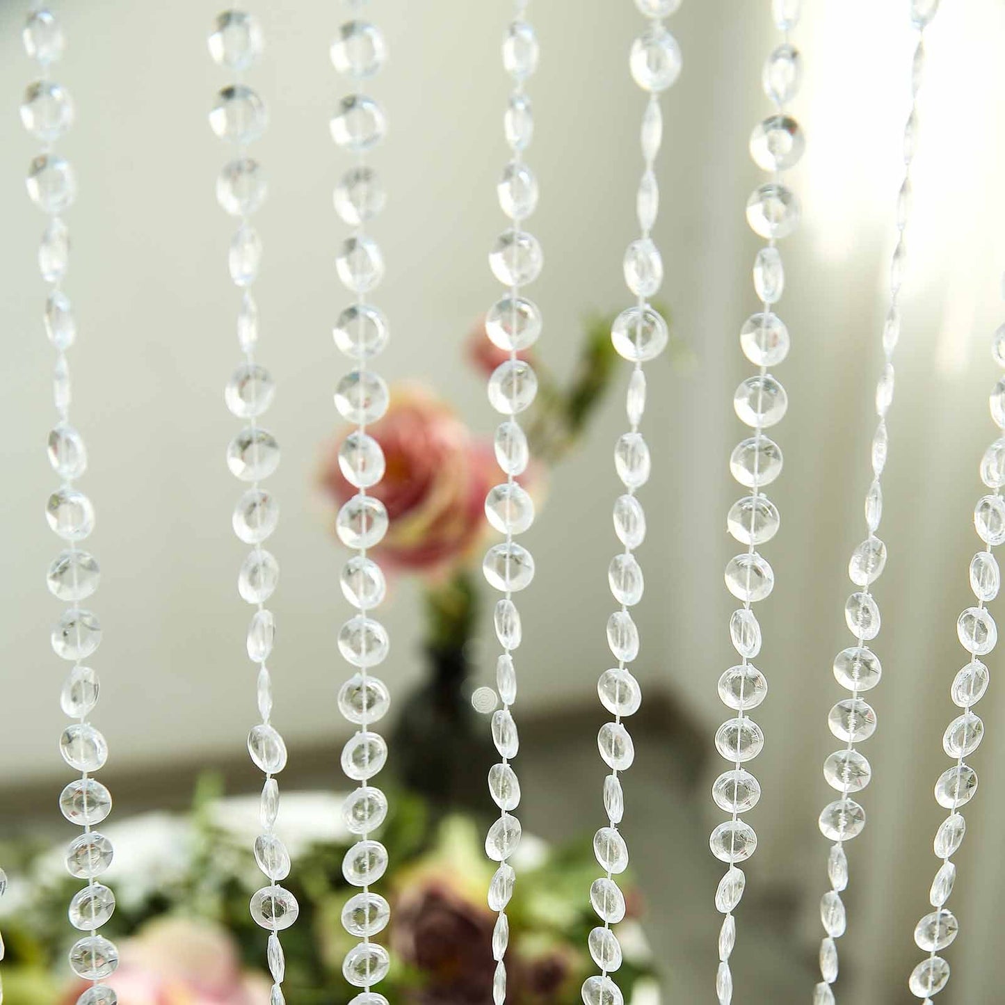 Clear crystal beaded curtain with adjustable hooks and plastic rod.