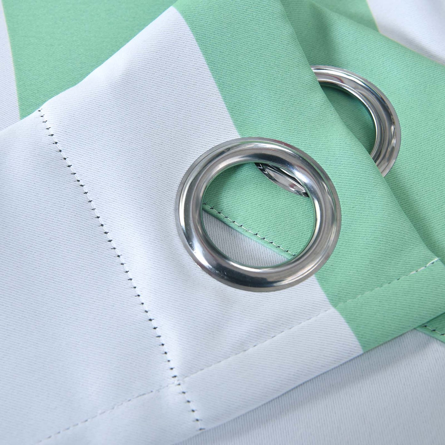White and mint cabana stripe thermal blackout curtains with chrome grommets.