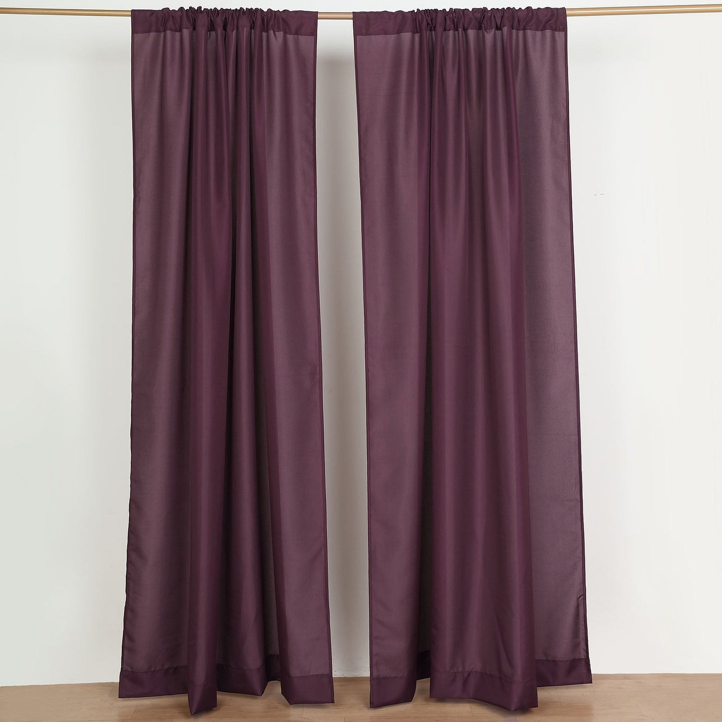 Eggplant polyester backdrop drape curtains with rod pockets.